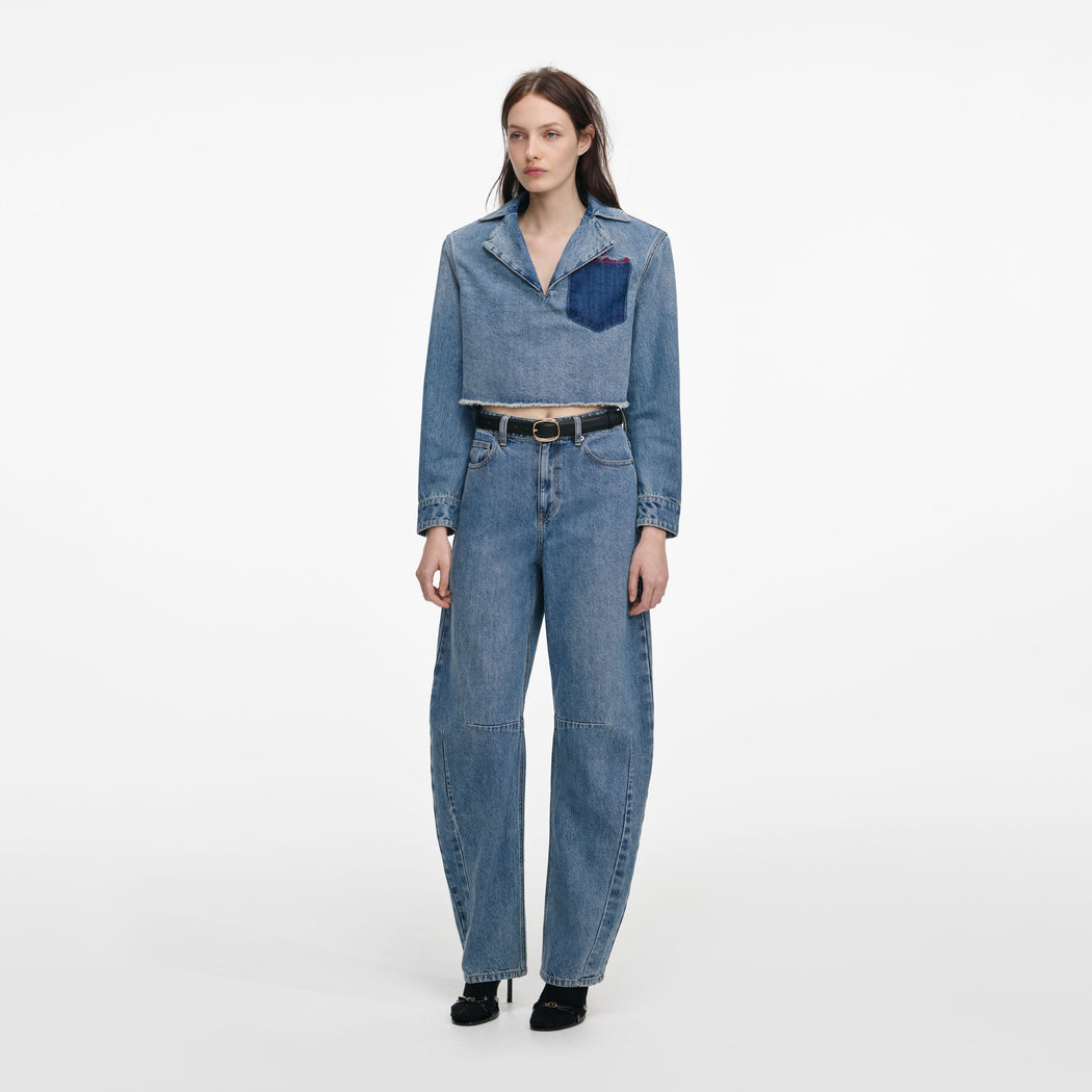 Side view of a woman wearing the Cropped Denim Shirt
