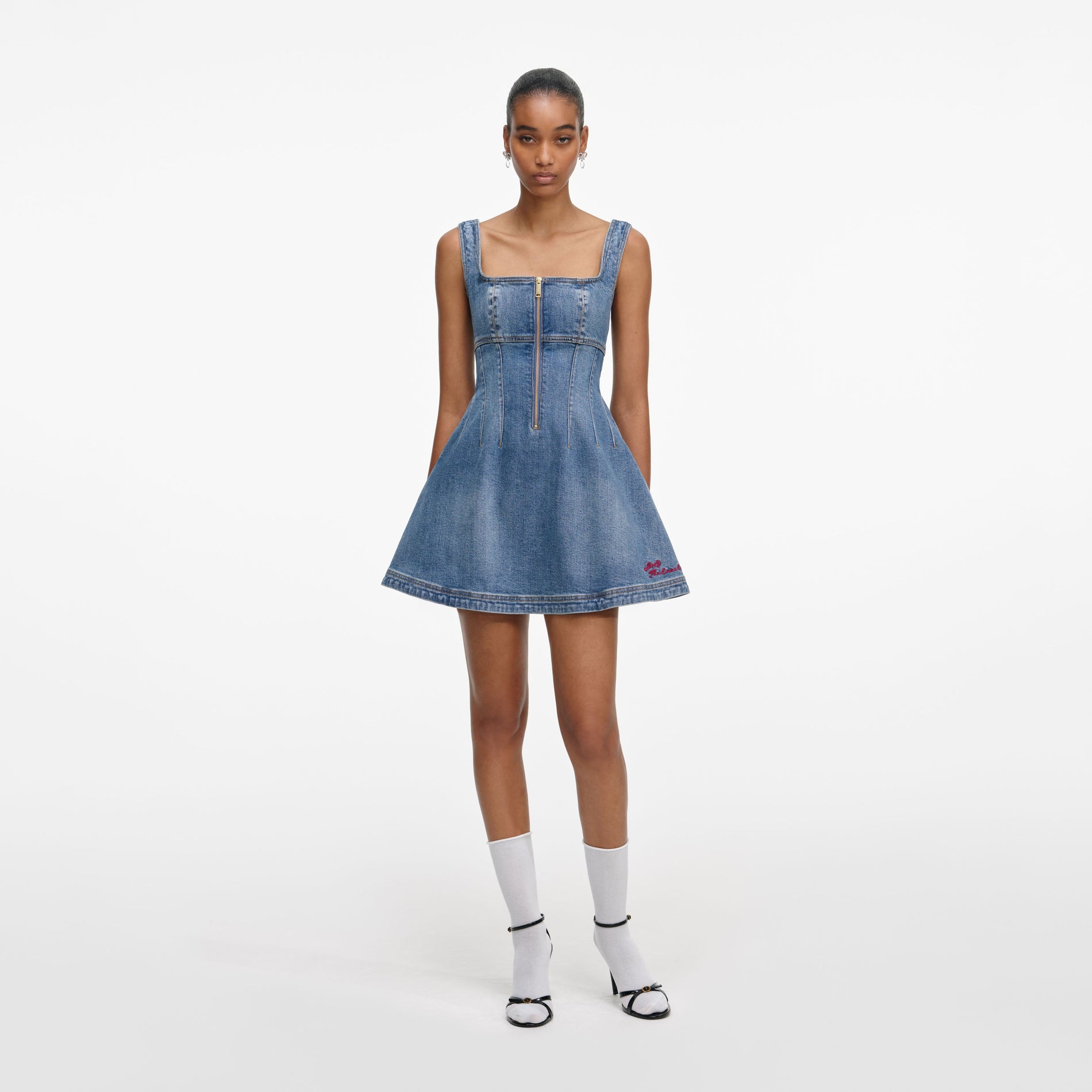 Front view of a woman wearing the Denim Flared Logo Mini Dress