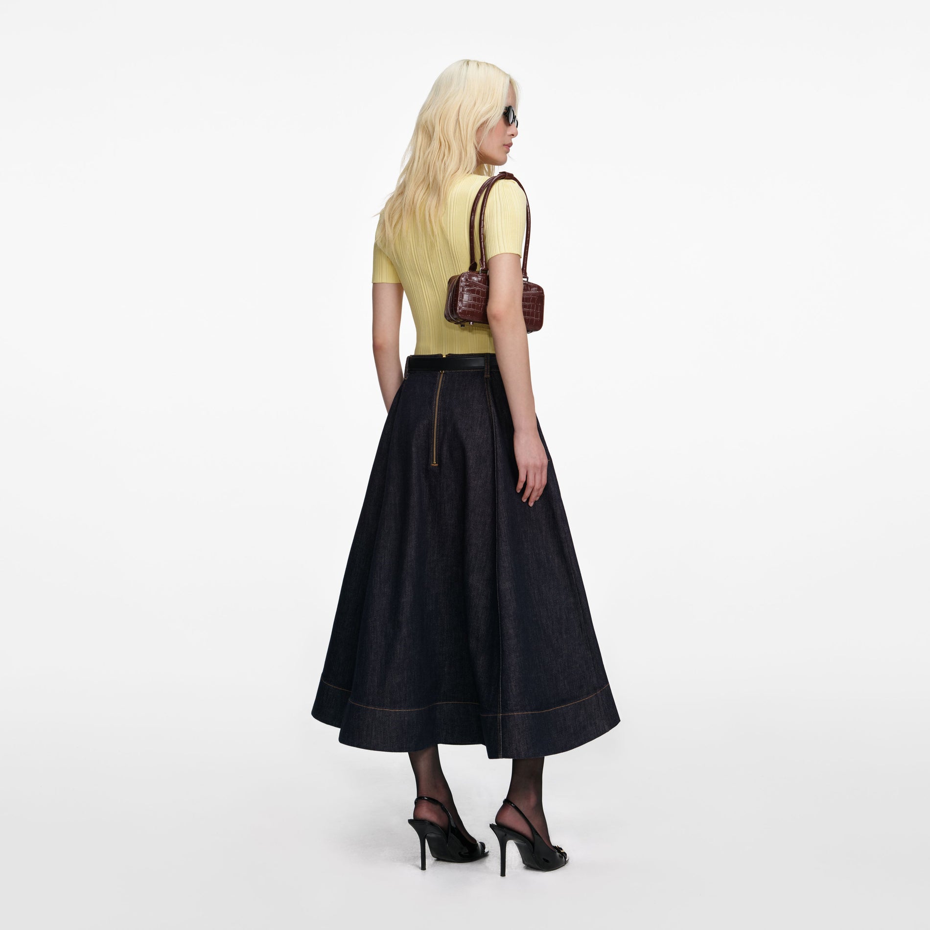 Back view of a woman wearing the Indigo Denim Flared Midi Skirt