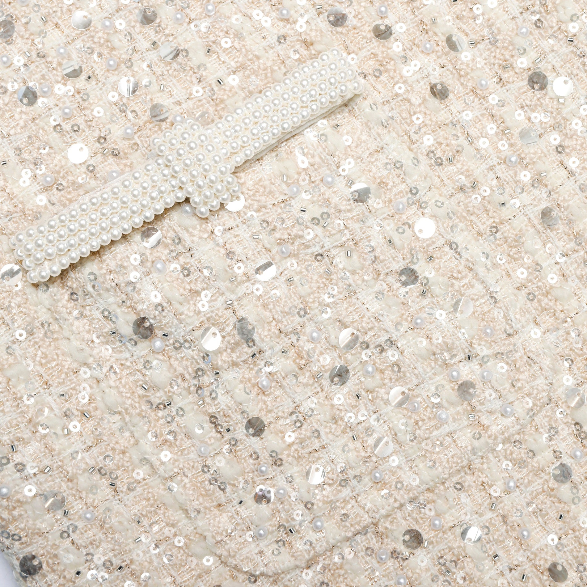 A close up of the fabric for the Cream Embellished Boucle Mini Dress