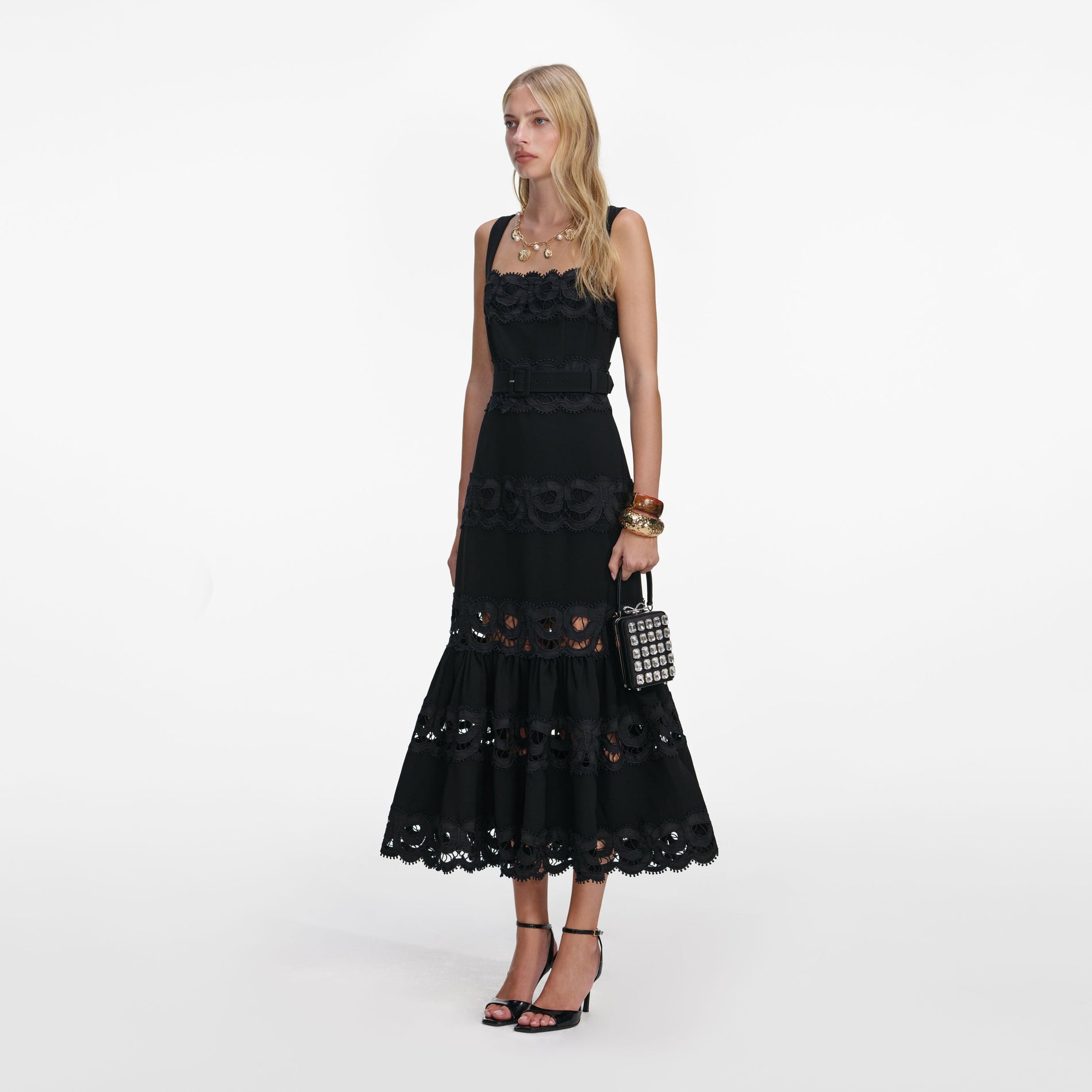 Side view of a woman wearing the Black Crepe Midi Dress