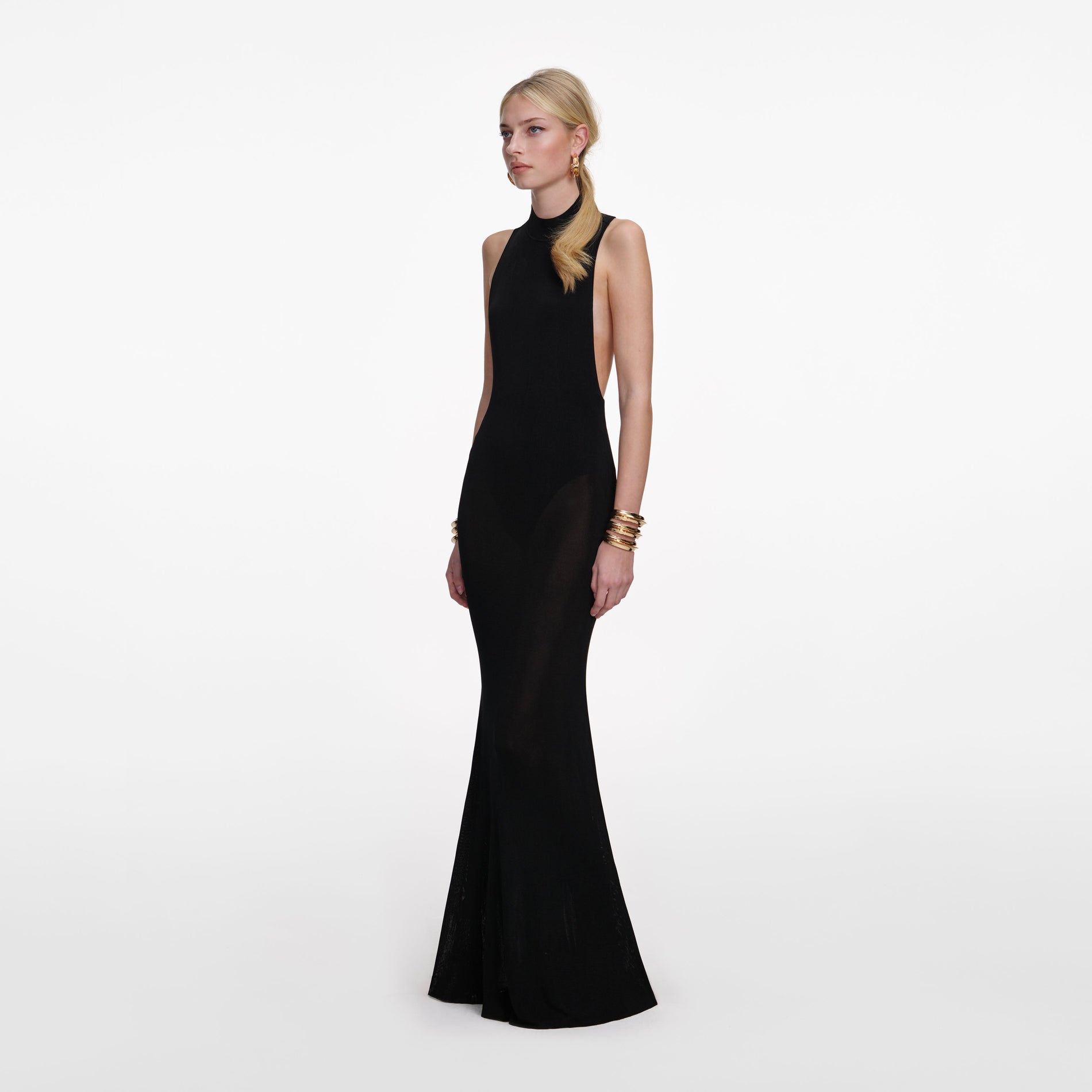 Side view of a woman wearing the Black Racer Back Viscose Knit Maxi Dress