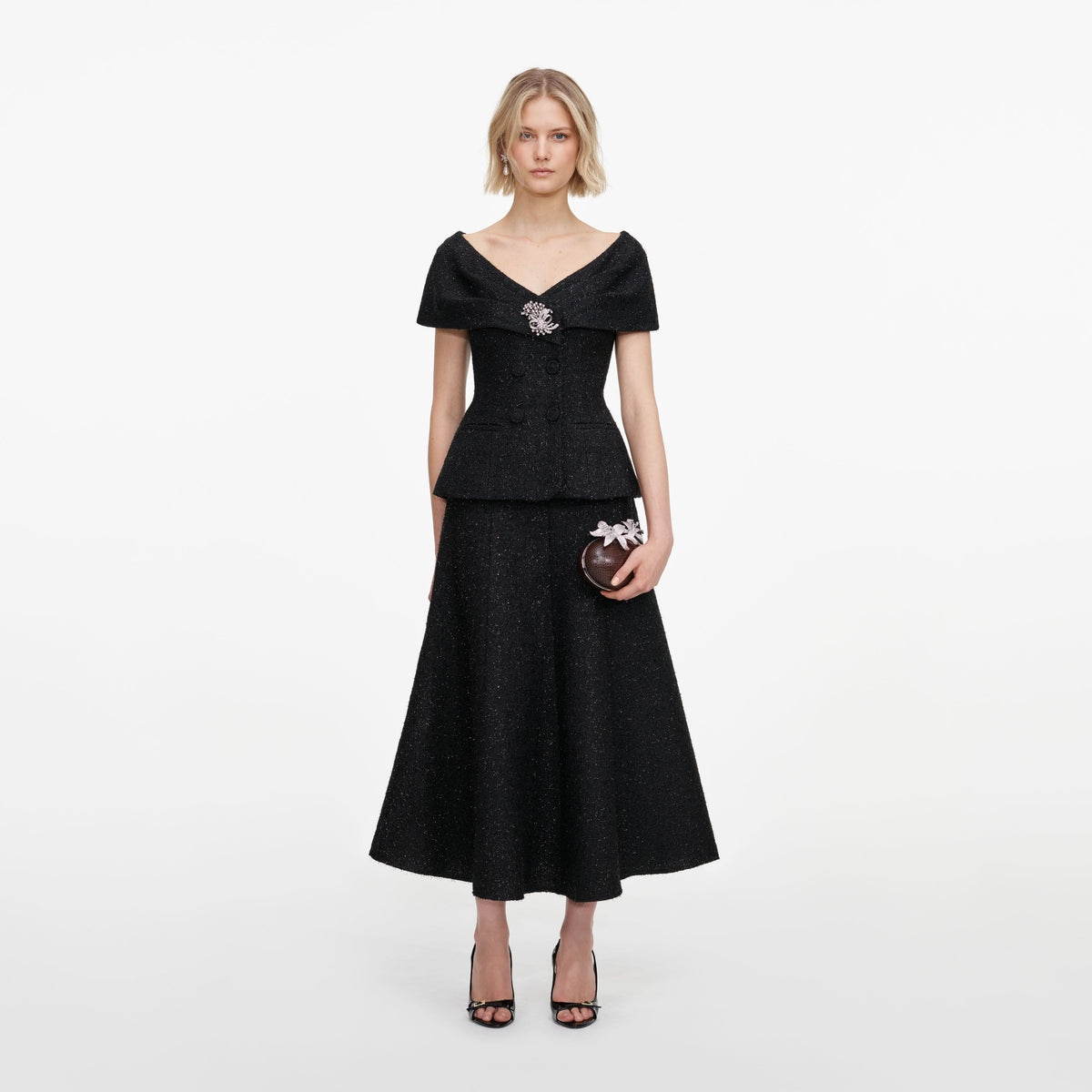 Front view of a woman wearing the Black Tinsel Boucle Brooch Midi Dress