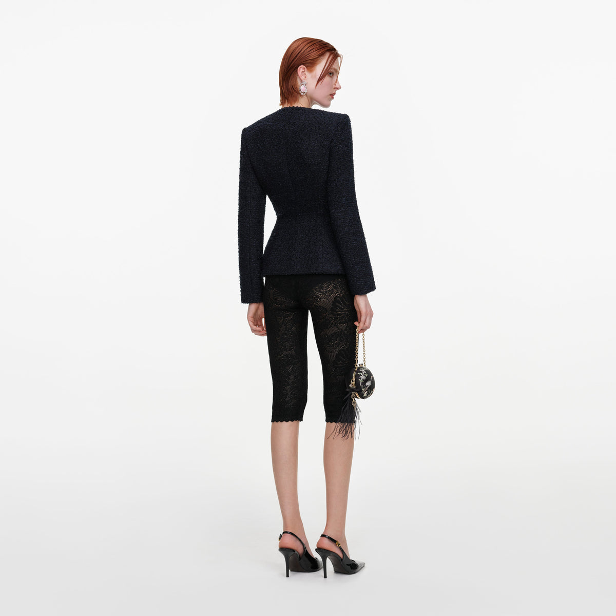 Back view of a woman wearing the Navy Boucle Jacket