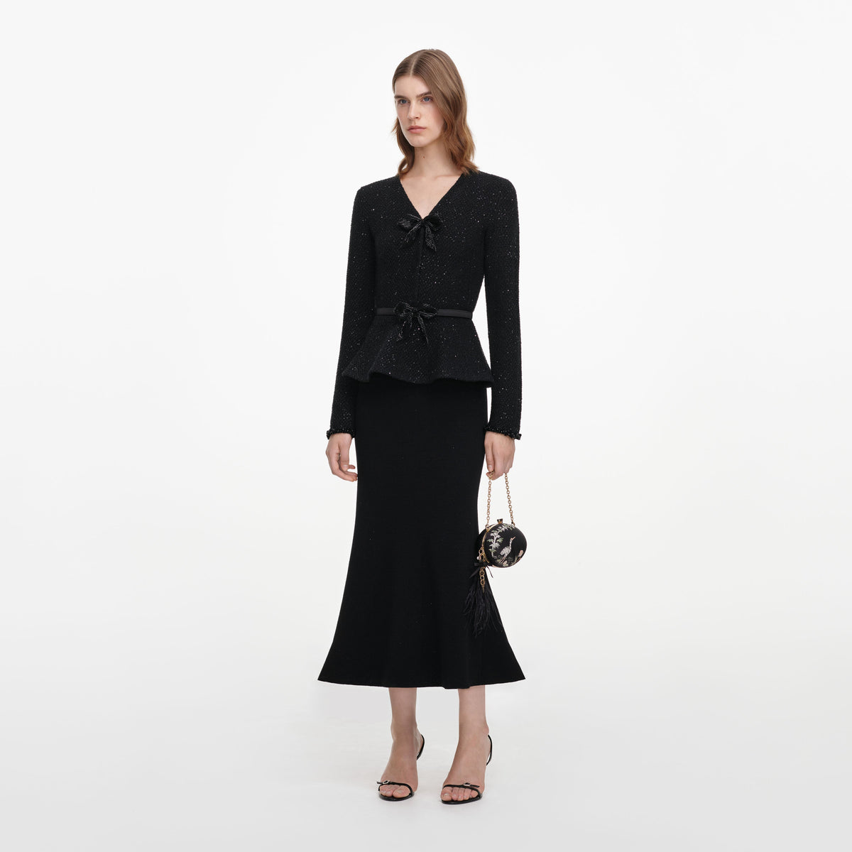 Side view of a woman wearing the Black Sequin Knit Midi Dress