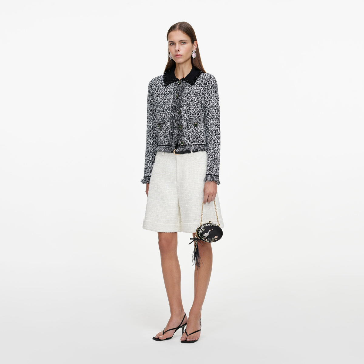 Side view of a woman wearing the Cream Sequin Boucle Tailored Shorts