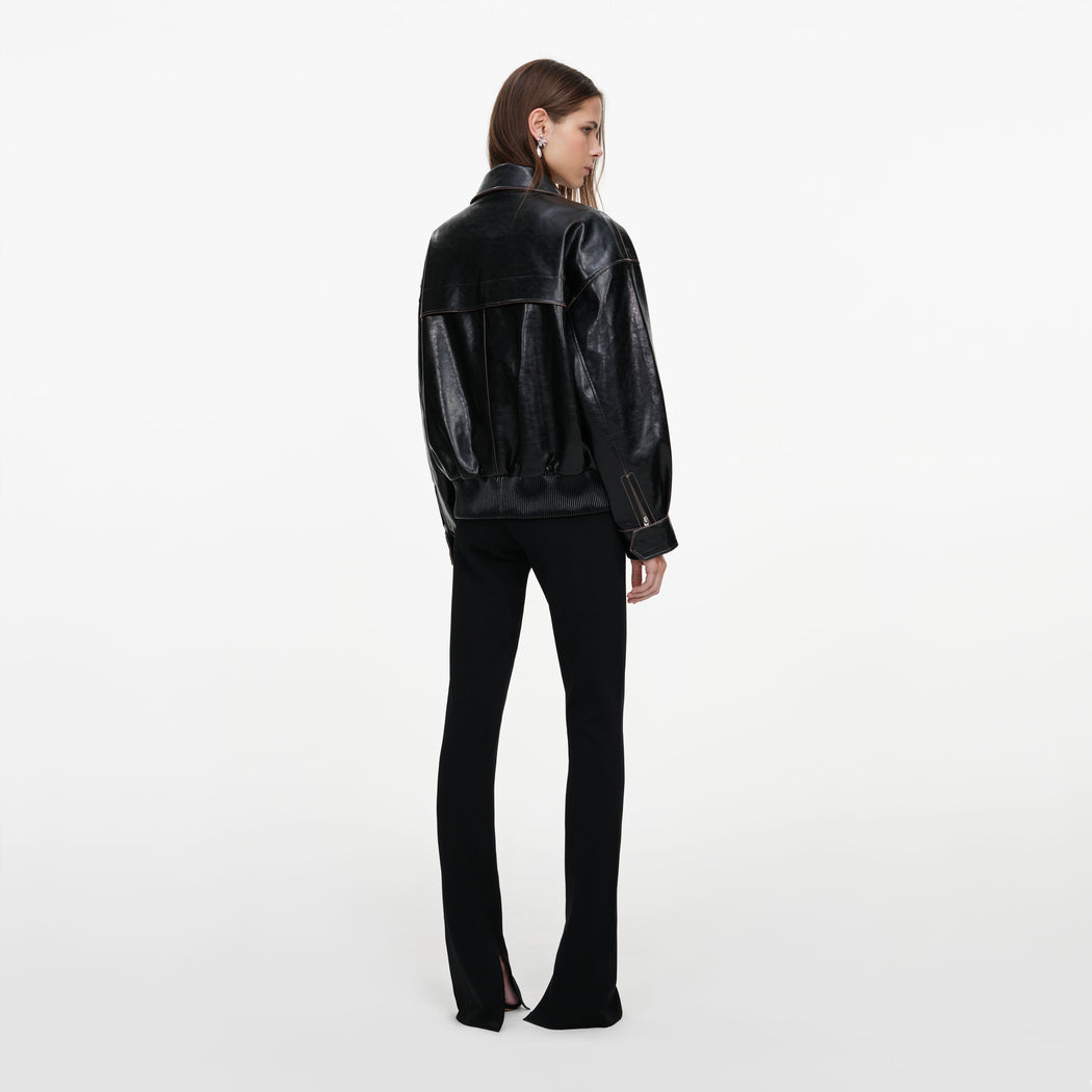 Back view of a woman wearing the Black Oversized Faux Leather Jacket