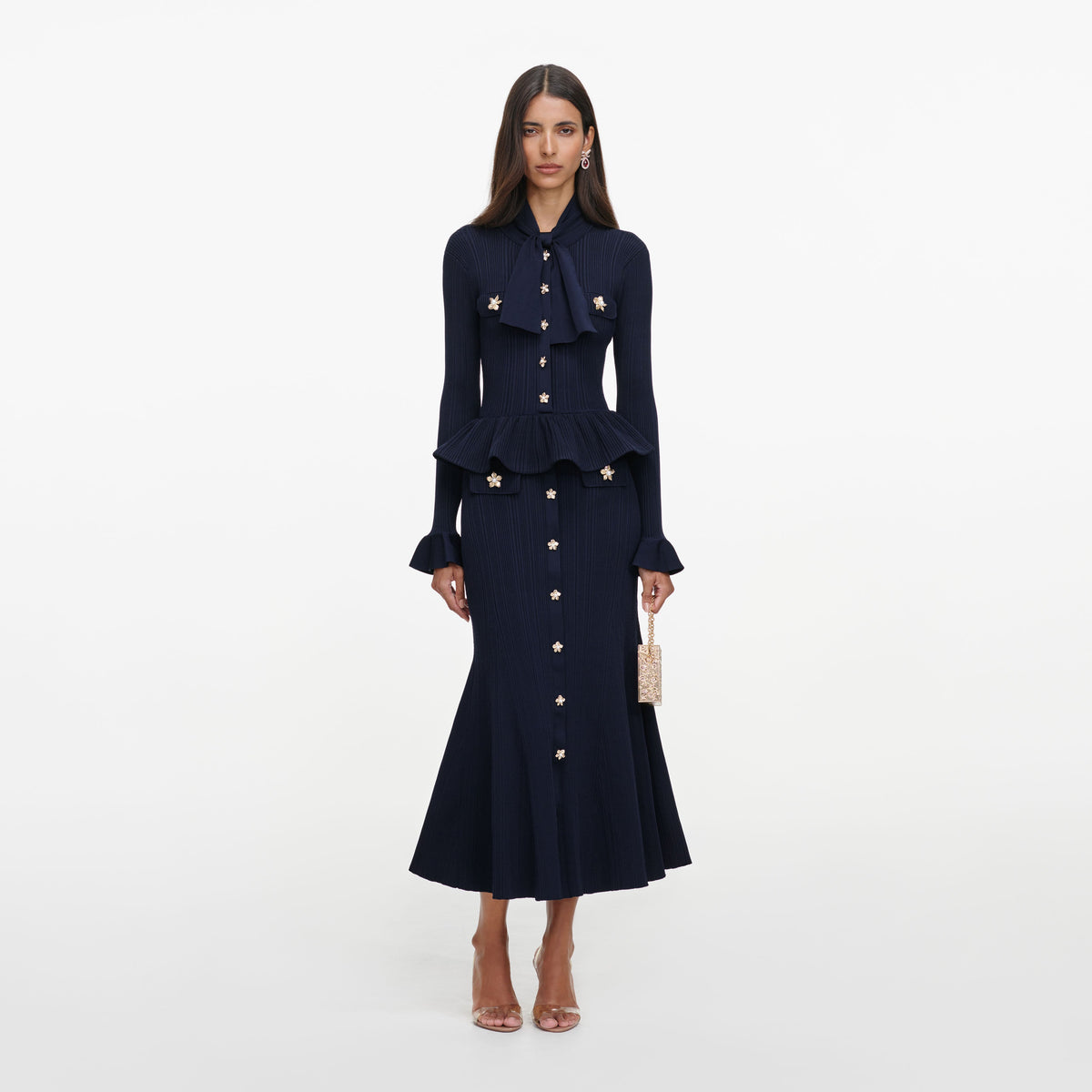 Front view of a woman wearing the Navy Peplum Knit Midi Dress