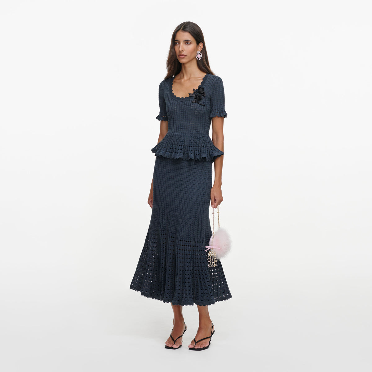 Side view of a woman wearing the Grey Pointelle Peplum Knit Midi Dress