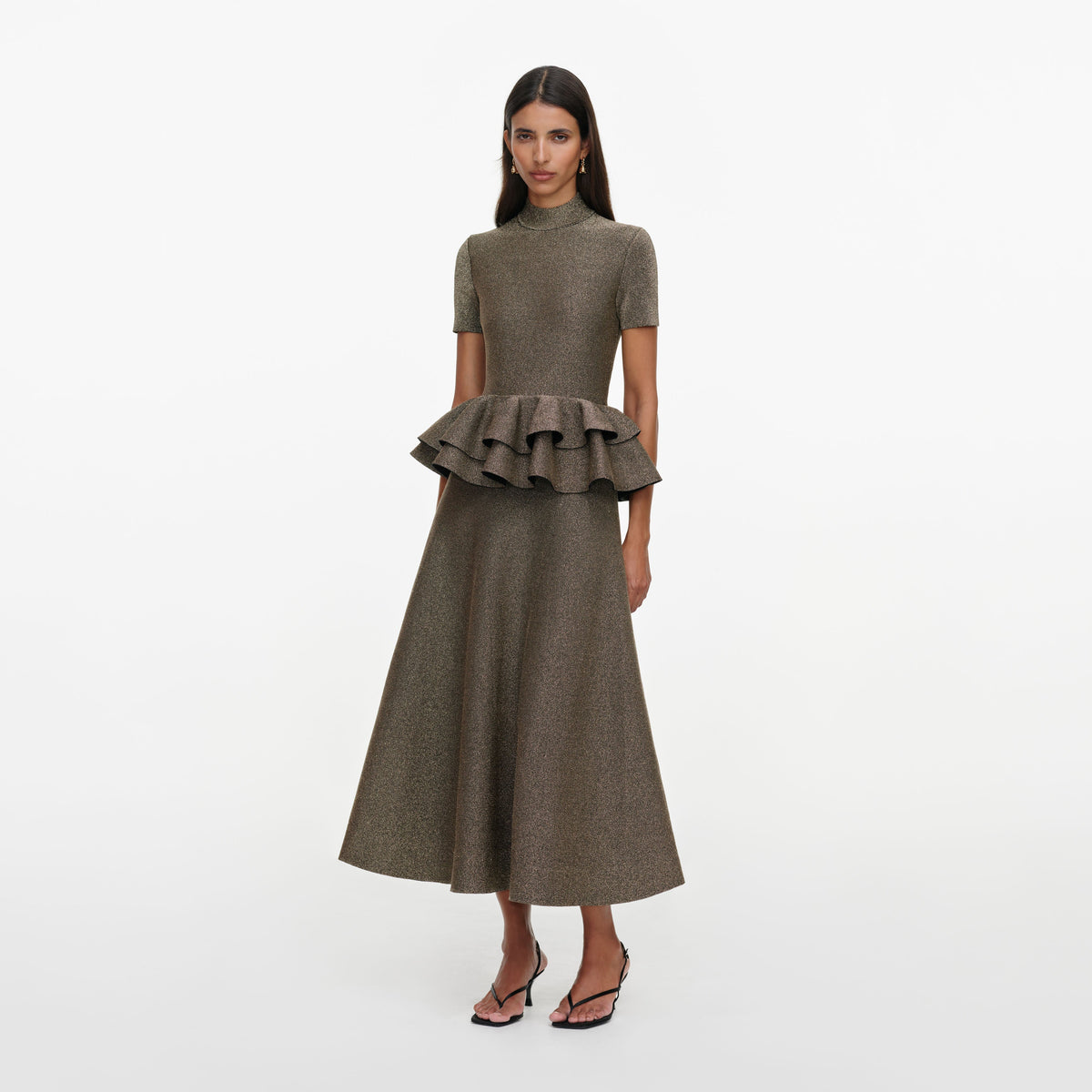 Side view of a woman wearing the Bronze Peplum Knit Midi Dress