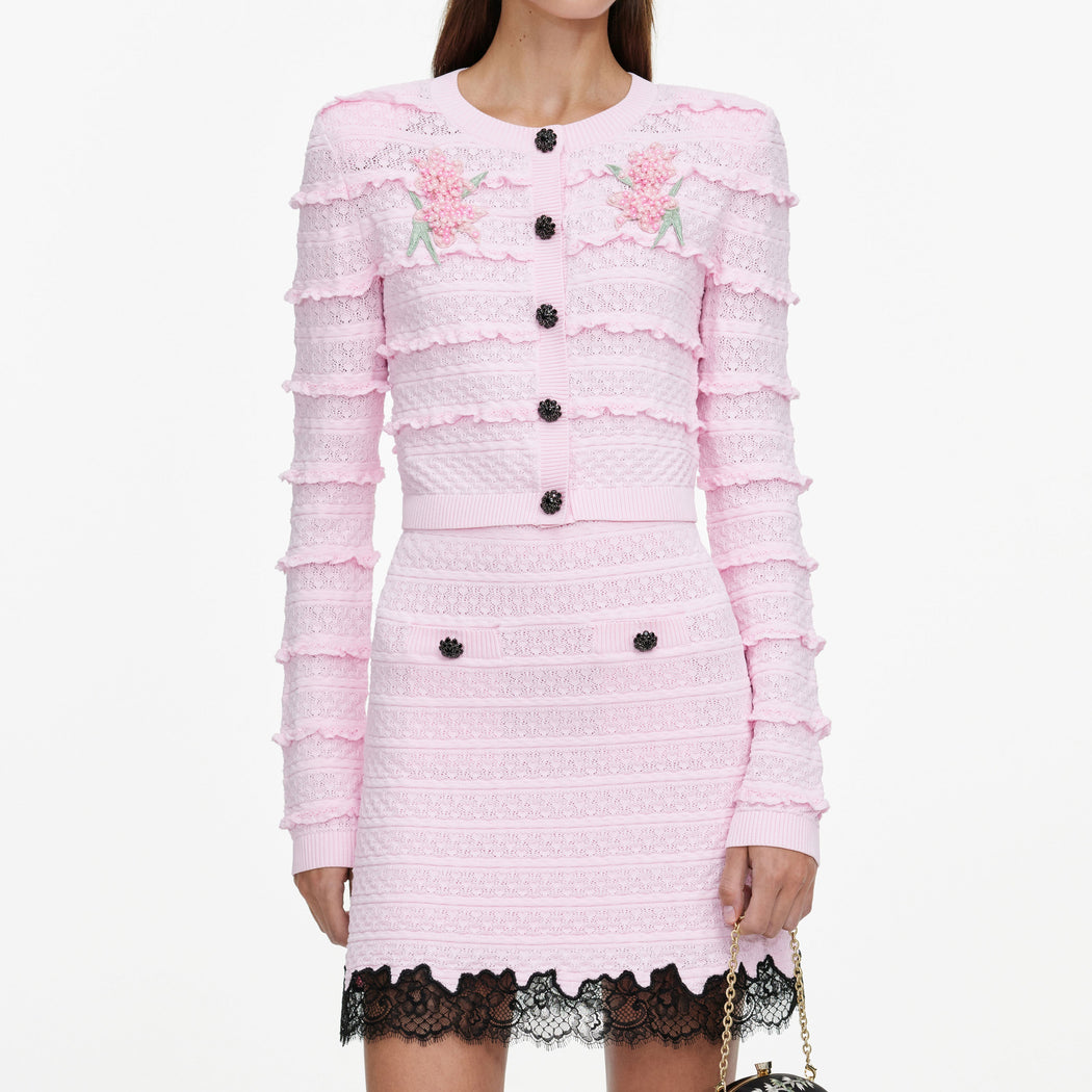 A close up of a woman wearing the Pink Pointelle Knit Skirt