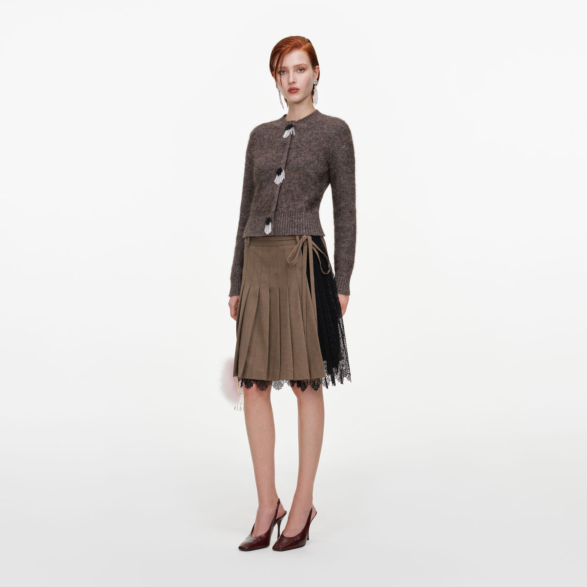 Side view of a woman wearing the Brown Twill Lace Pleated Midi Skirt