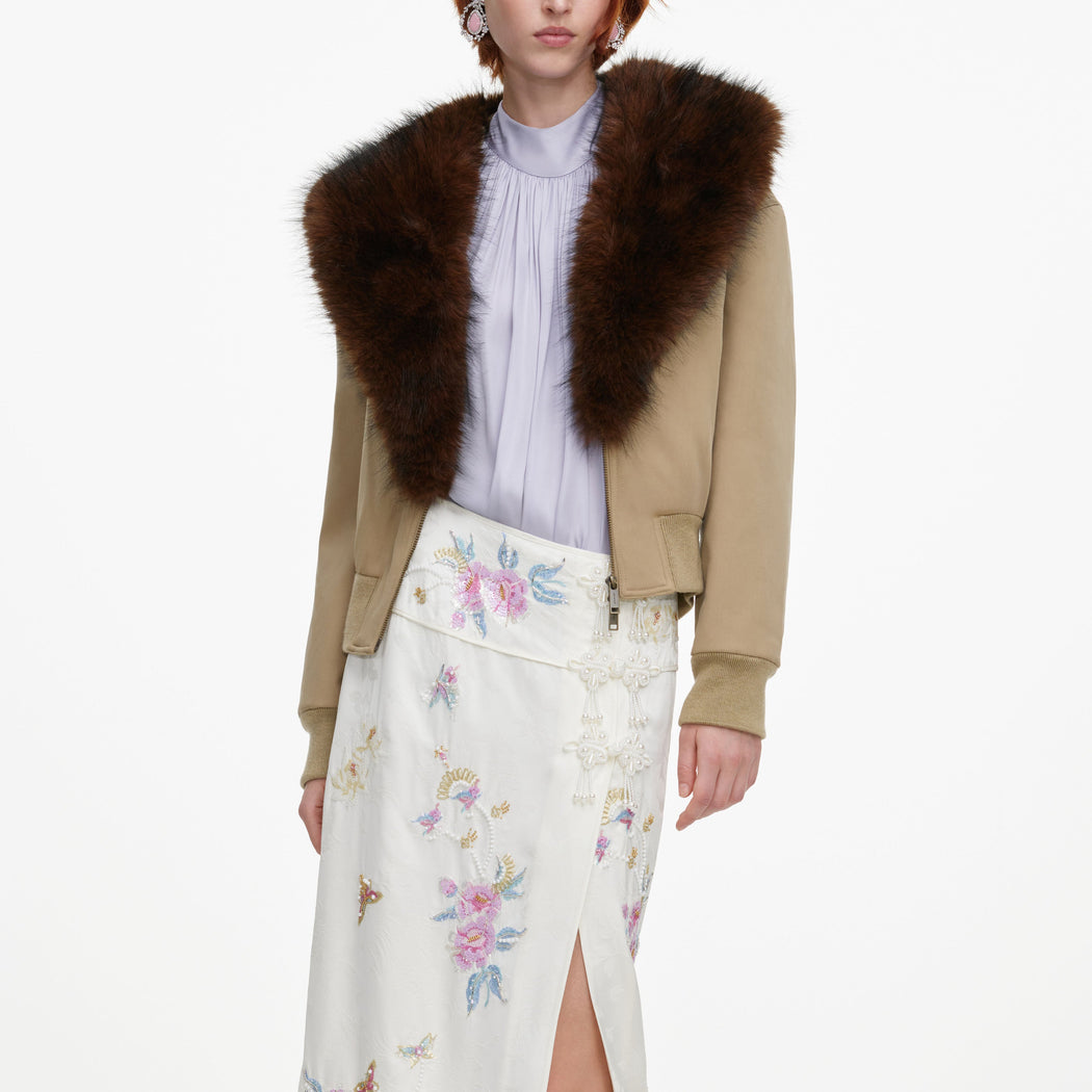 A close up of a woman wearing the Cream Jacquard Floral Midi Skirt