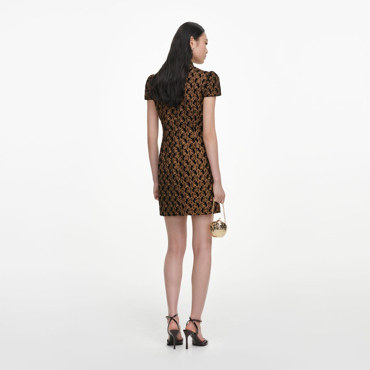 Back view of a woman wearing the Black Velvet Flower Mini Dress