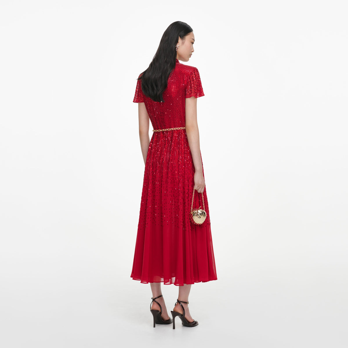 Back view of a woman wearing the Red Ombre Rhinestone Twist Midi Dress