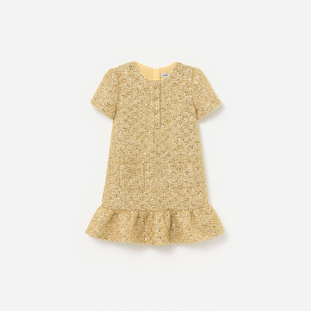 Front view of a girl wearing the Gold Boucle Dress