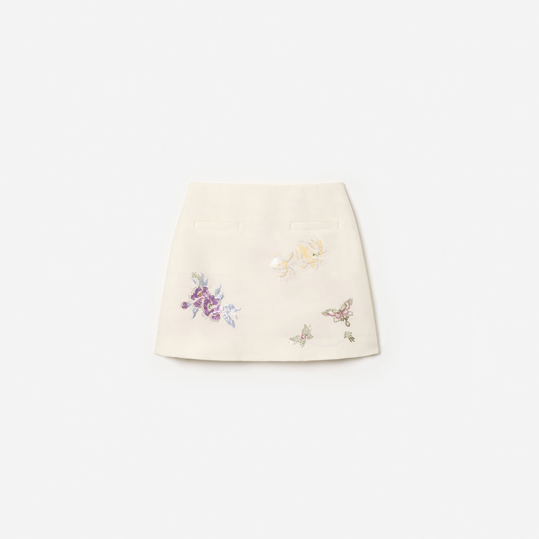 Front view of a girl wearing the Cream Floral Jacquard Skirt