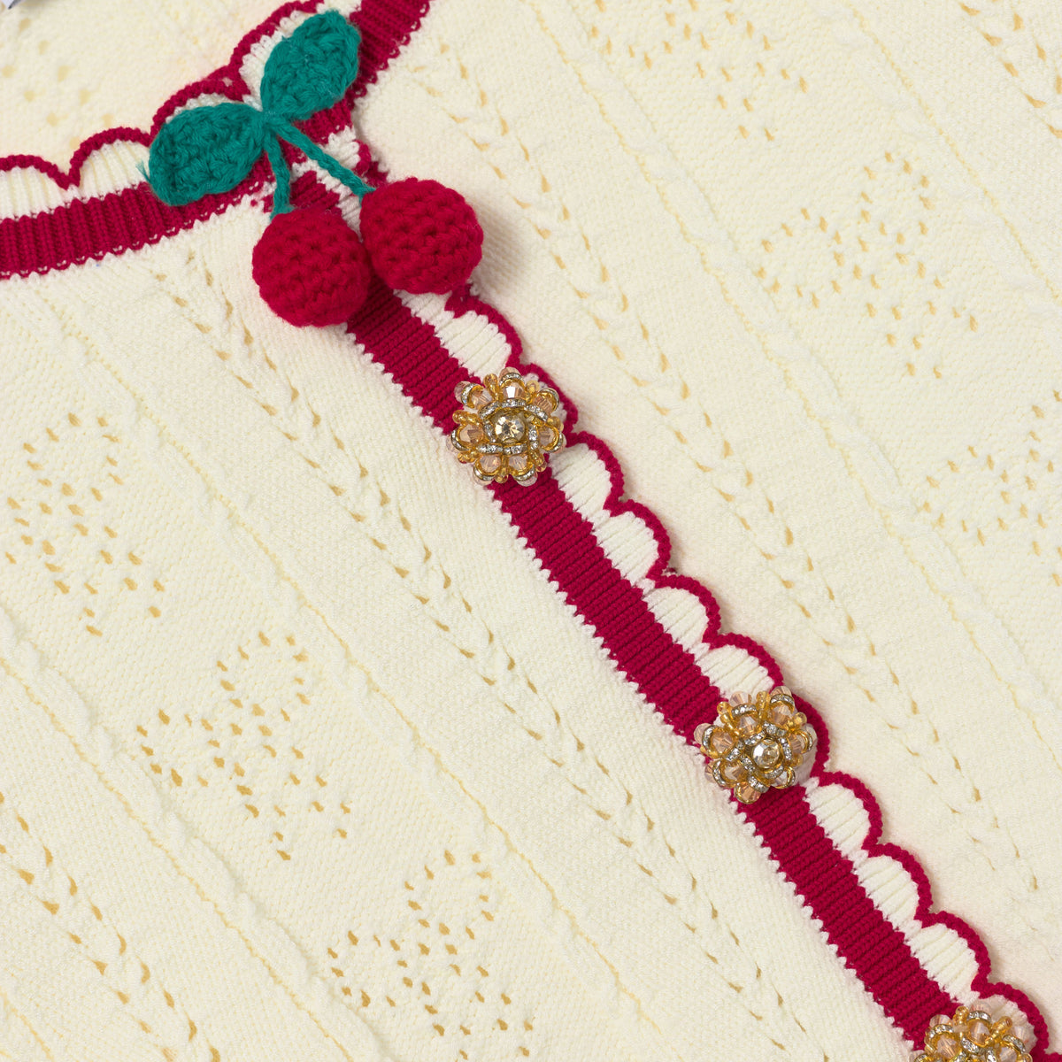 Detail Shot of the Cream Pointelle Knit Stripe Cherry Cardigan