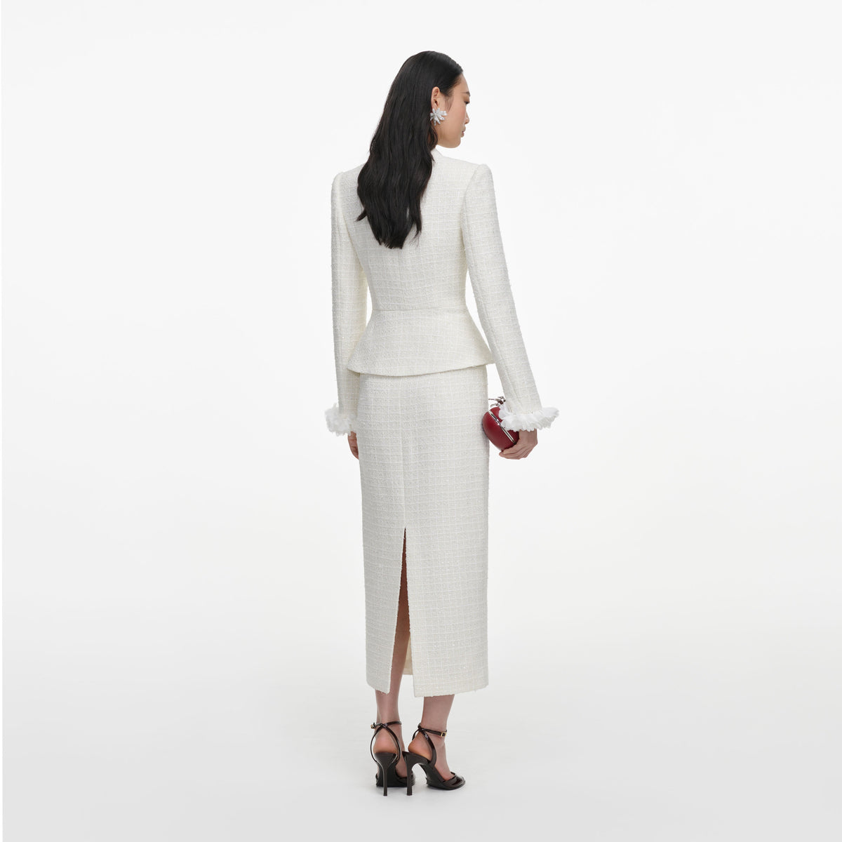 Back view of a woman wearing the Cream Boucle Flower Midi Dress