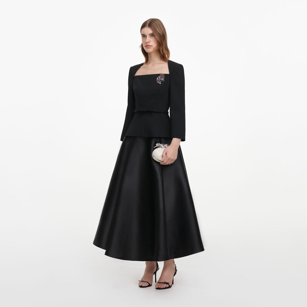Side view of a woman wearing the Black Taffeta Brooch Midi Dress