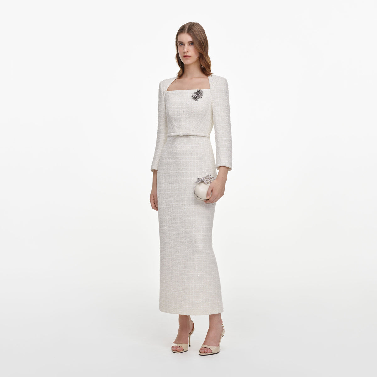 Side view of a woman wearing the Cream Tailored Boucle Brooch Midi Dress