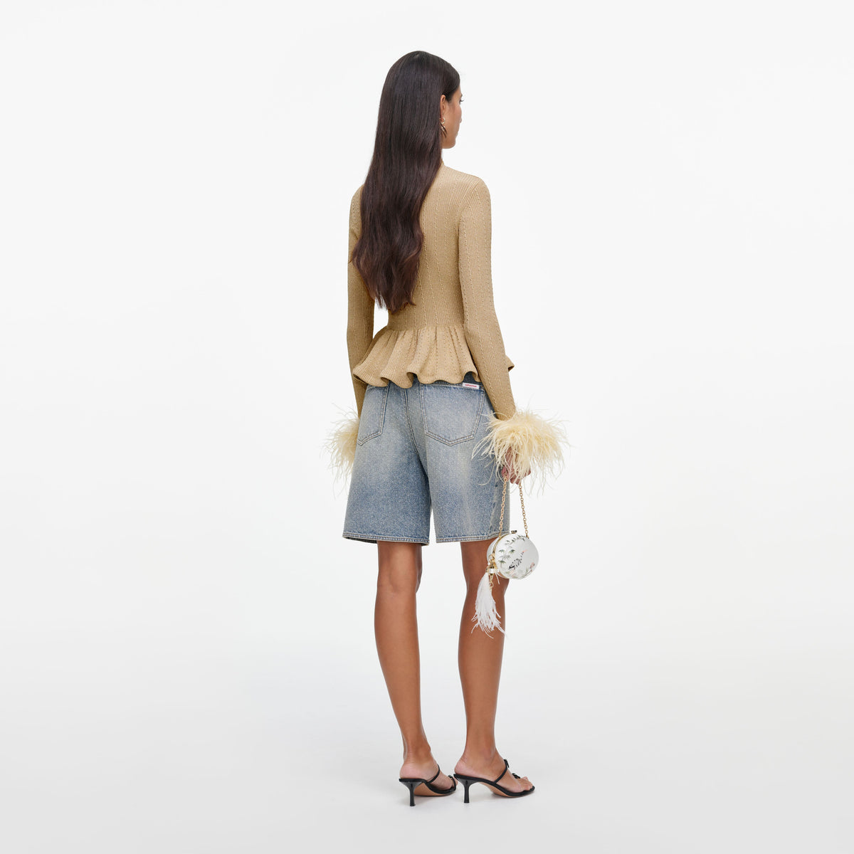 Back view of a woman wearing the Gold Metallic Feather Knit Top
