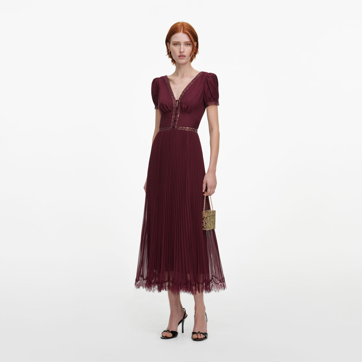 Side view of a woman wearing the Burgundy Viscose Pleated Lace Midi Dress