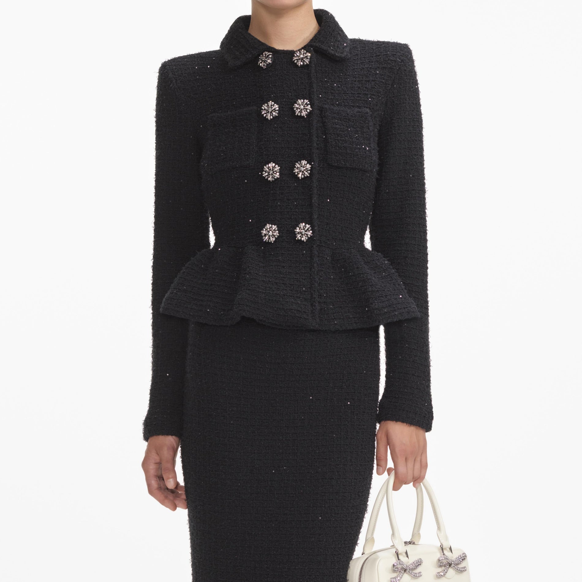 A close up of a woman wearing the Black Textured Knit Peplum Midi Dress