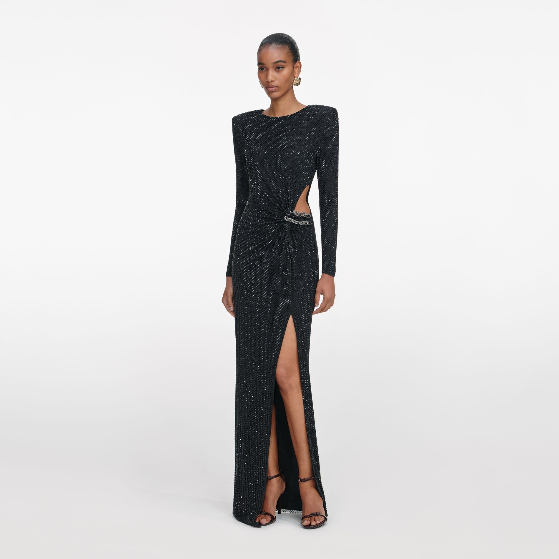 Side view of a woman wearing the Black Rhinestone Embellished Maxi Dress