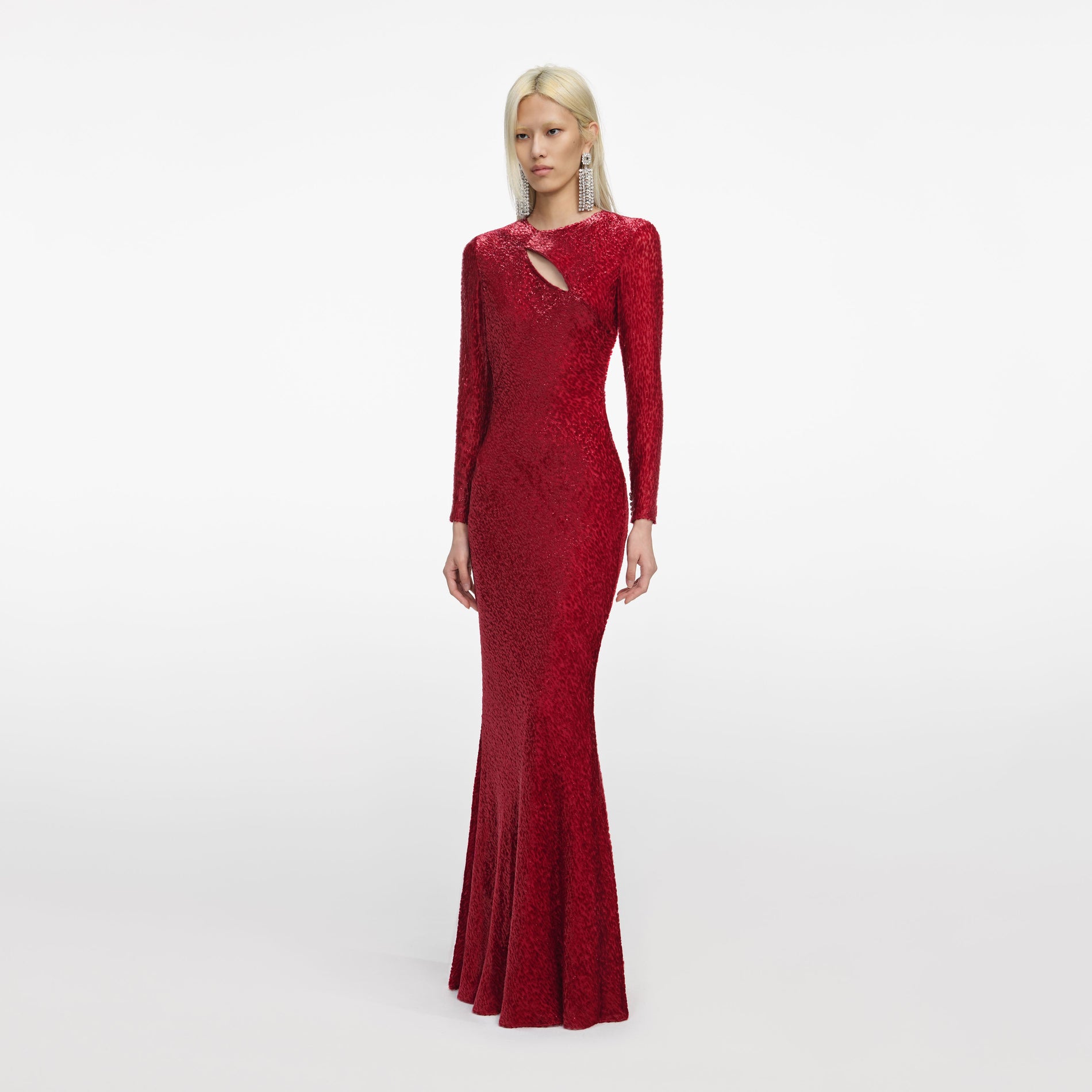 Side view of a woman wearing the Red Fil Coupe Maxi Dress