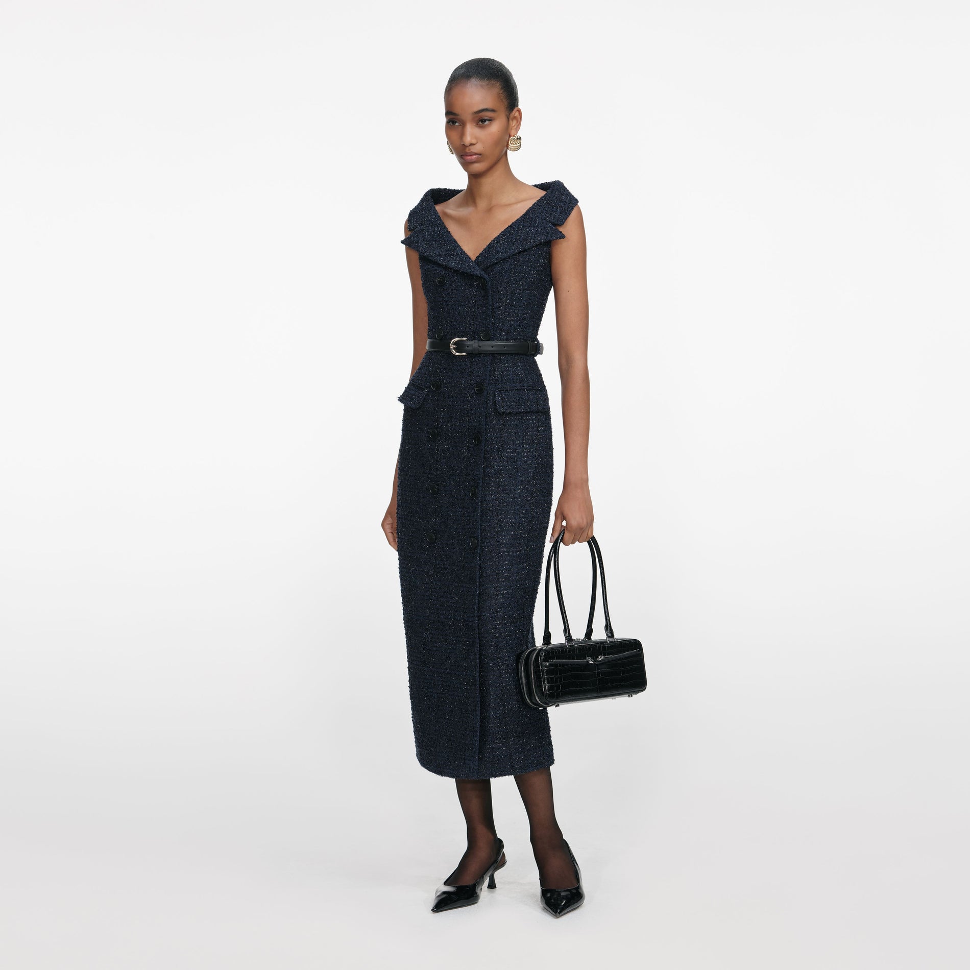 Side view of a woman wearing the Navy Boucle Midi Dress