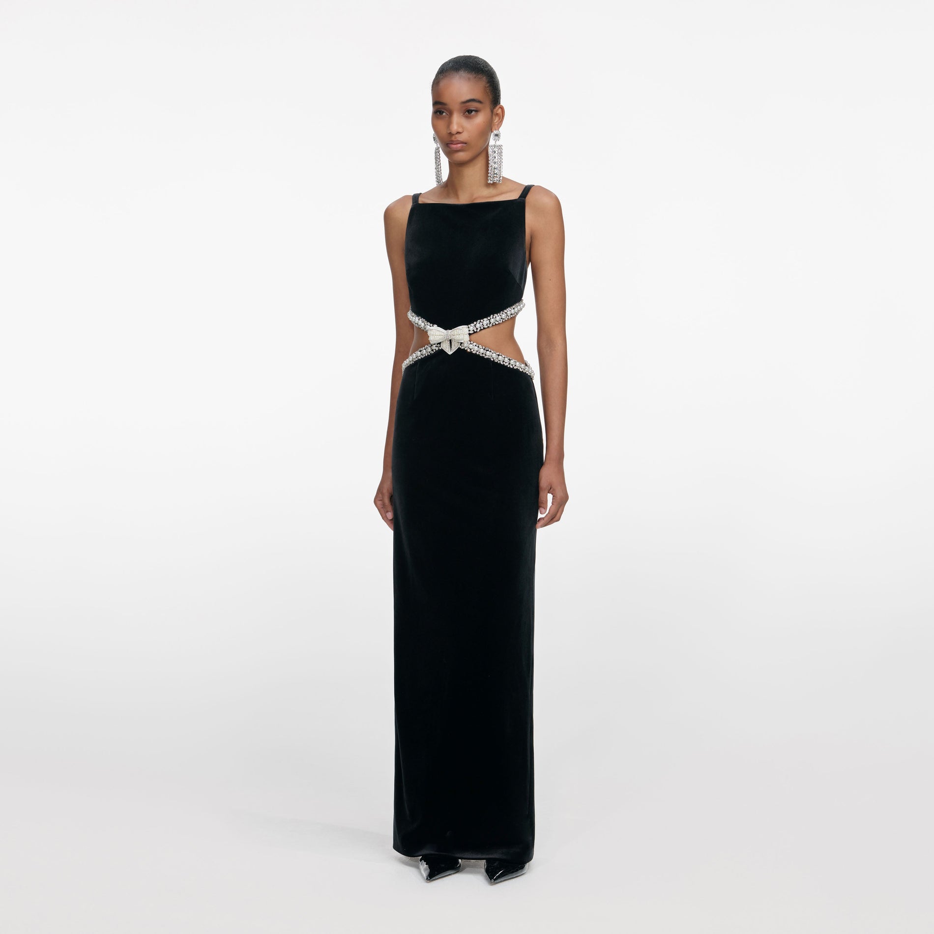 Side view of a woman wearing the Black Velvet Cut Out Maxi Dress