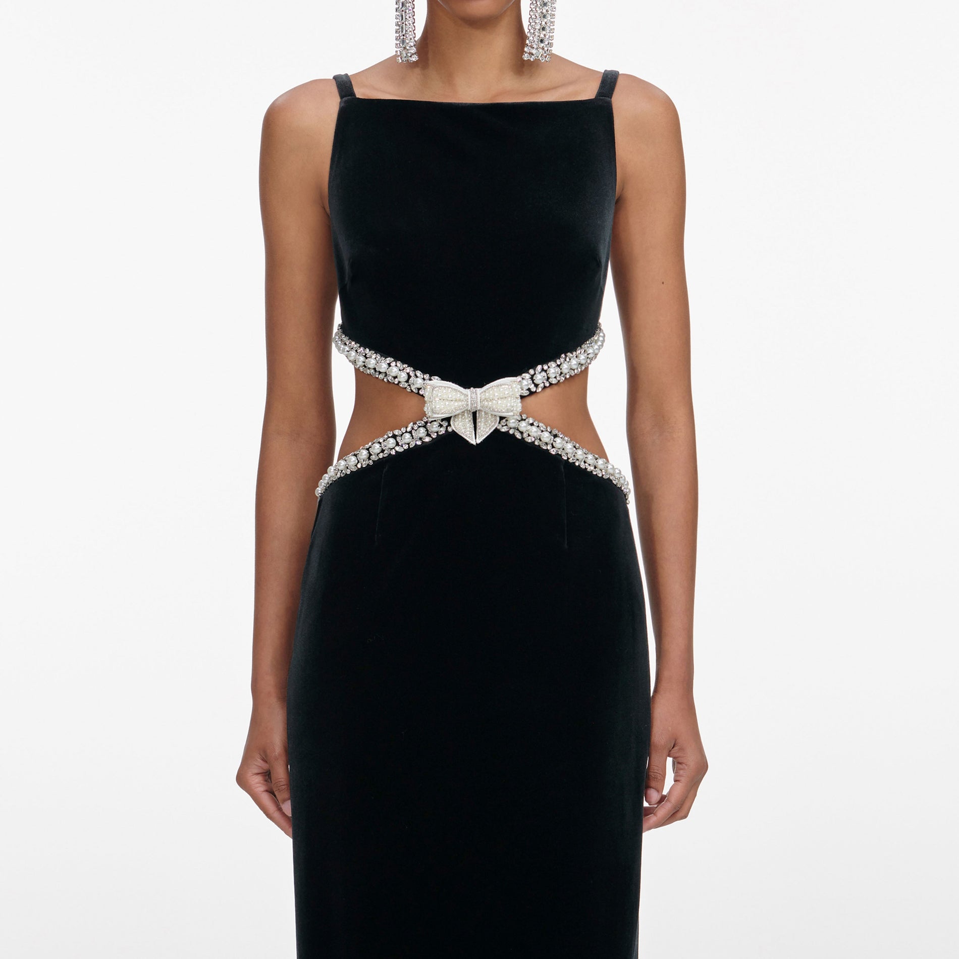 A close up of a woman wearing the Black Velvet Cut Out Maxi Dress