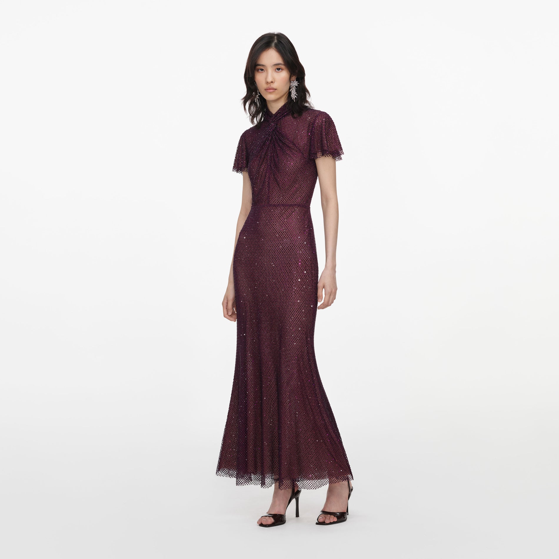 Side view of a woman wearing the Burgundy Rhinestone Fishnet Midi Dress