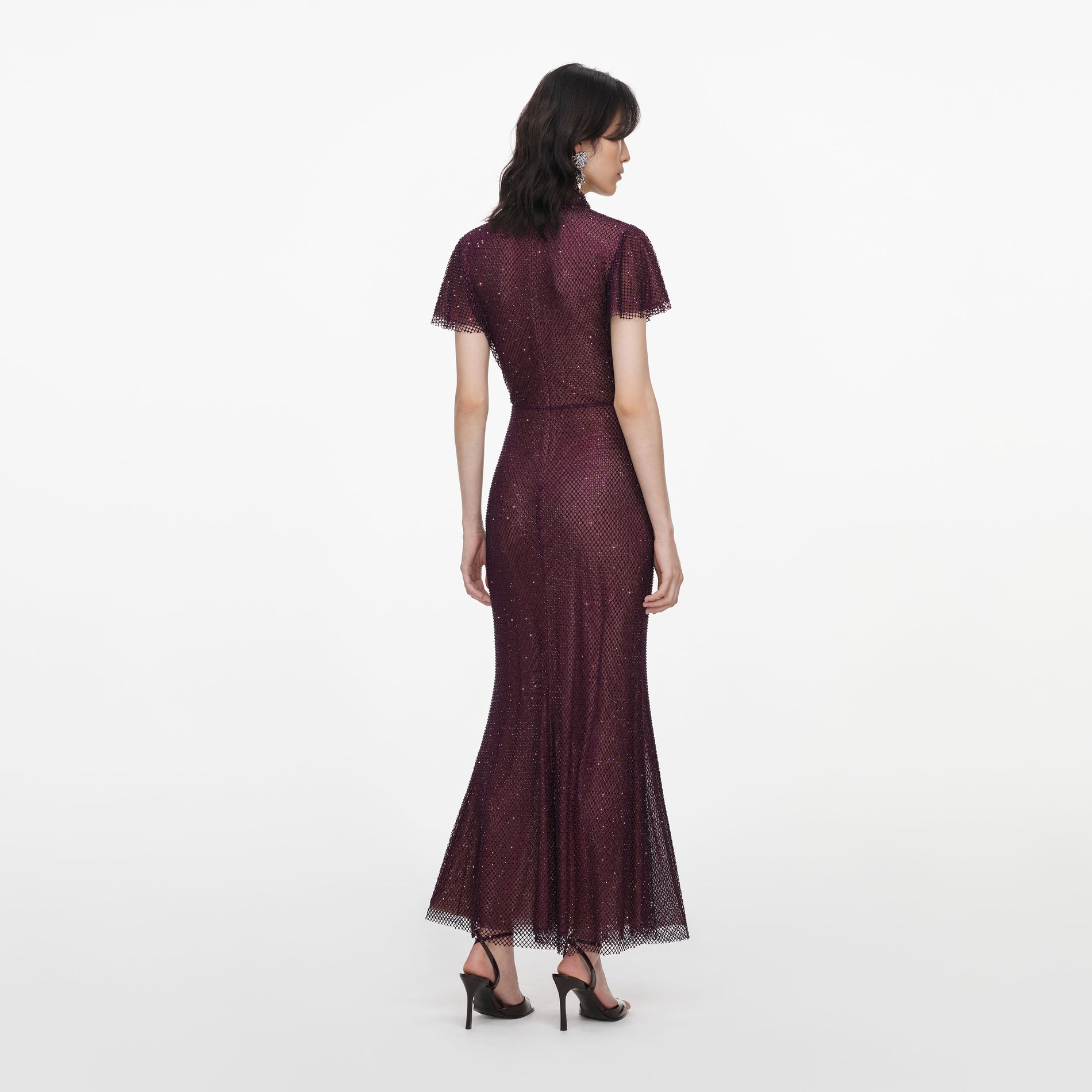 Back view of a woman wearing the Burgundy Rhinestone Fishnet Midi Dress