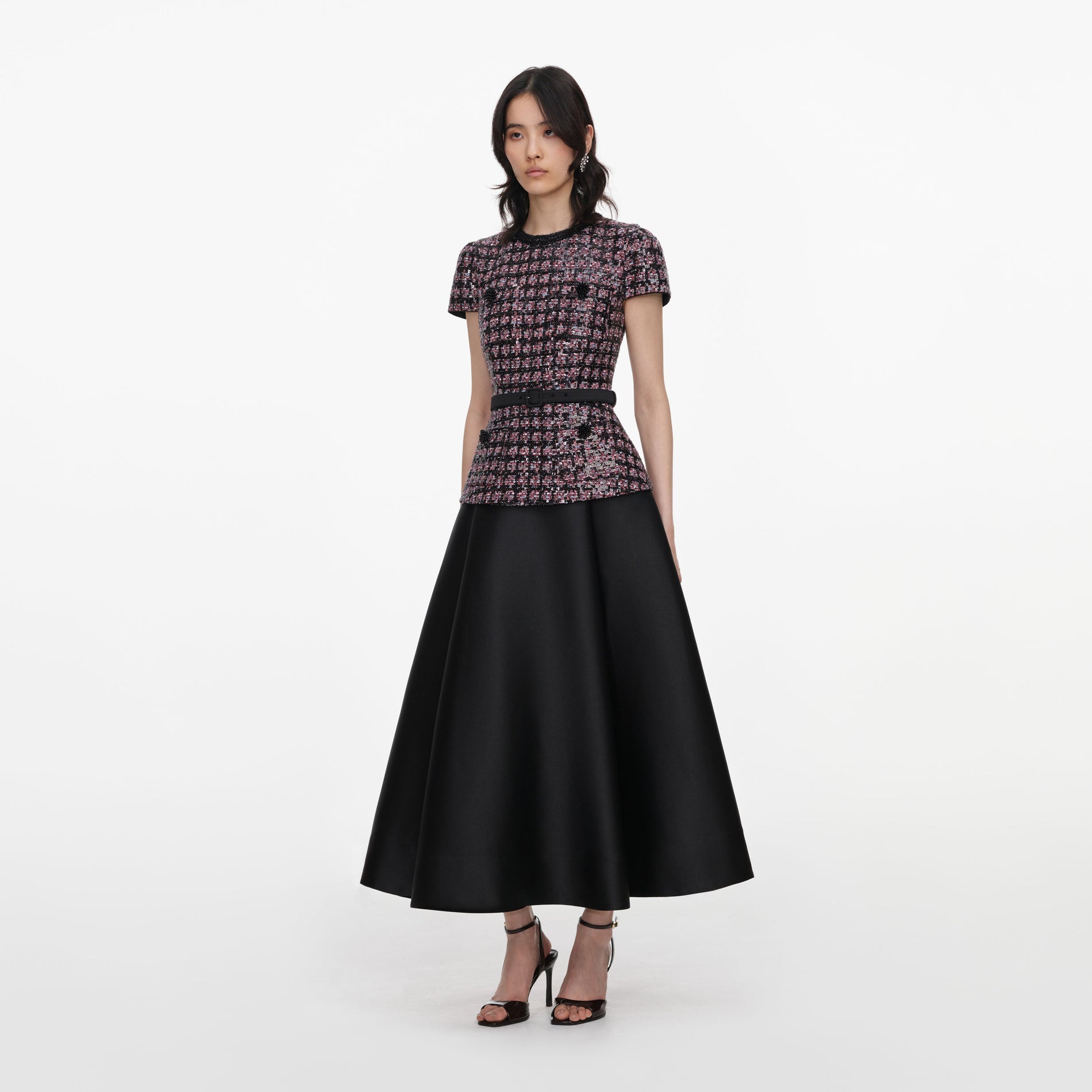 Side view of a woman wearing the Pink and Black Sequin Boucle Midi Dress