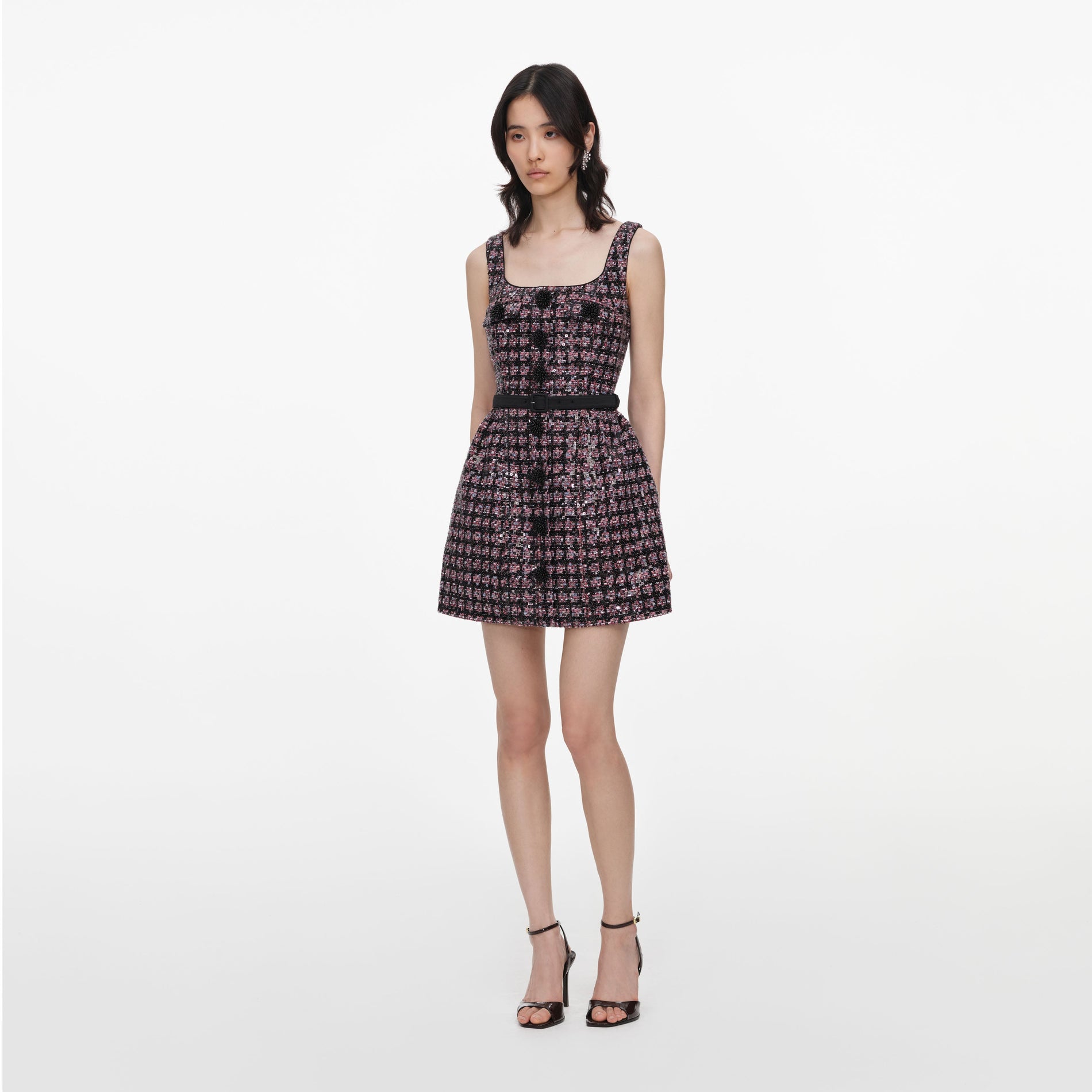 Side view of a woman wearing the Pink and Black Sequin Boucle Sleeveless Mini Dress