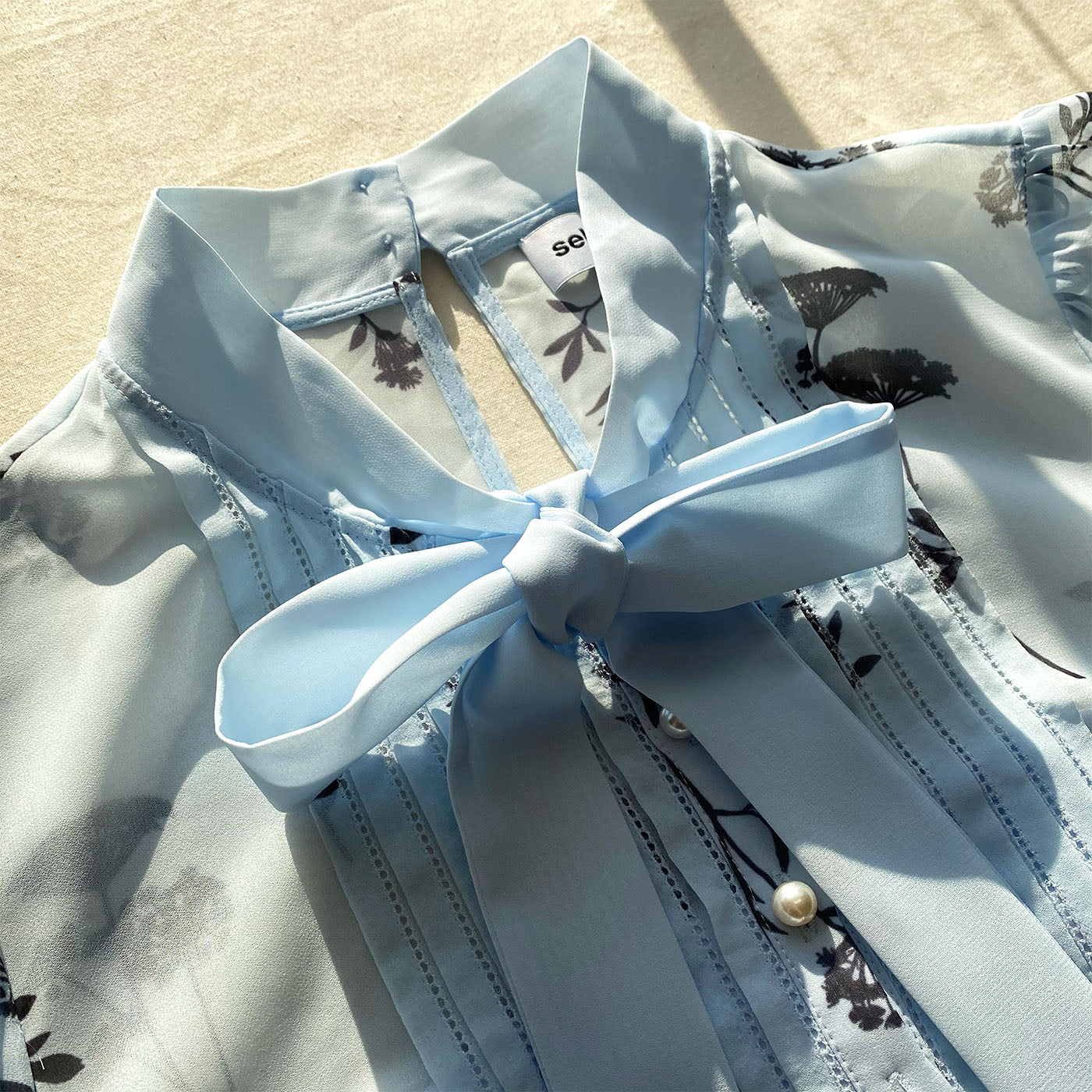 A close up of the fabric for the Blue Floral Silhouette Chiffon Midi Dress