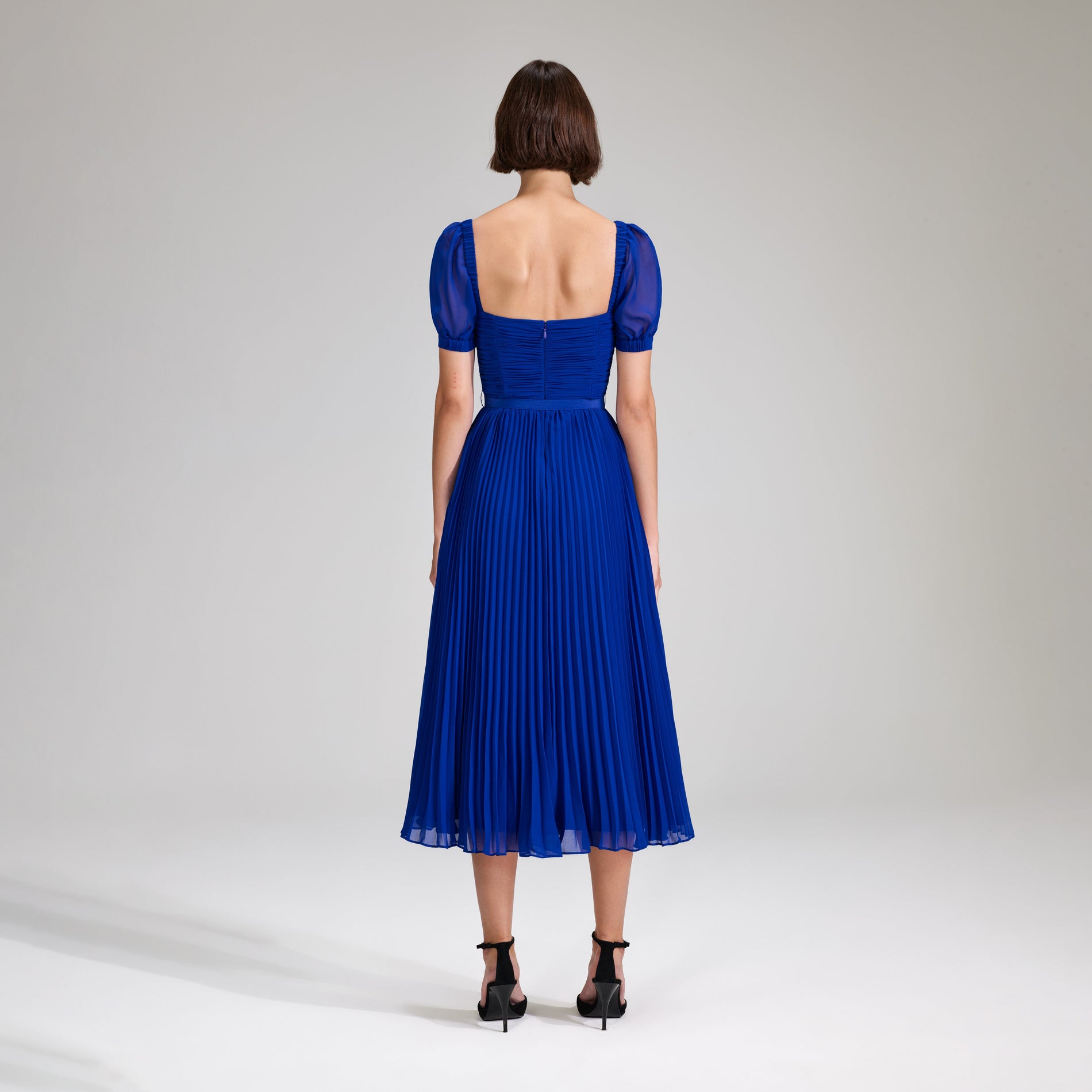A woman wearing the Cobalt Chiffon Midi Dress