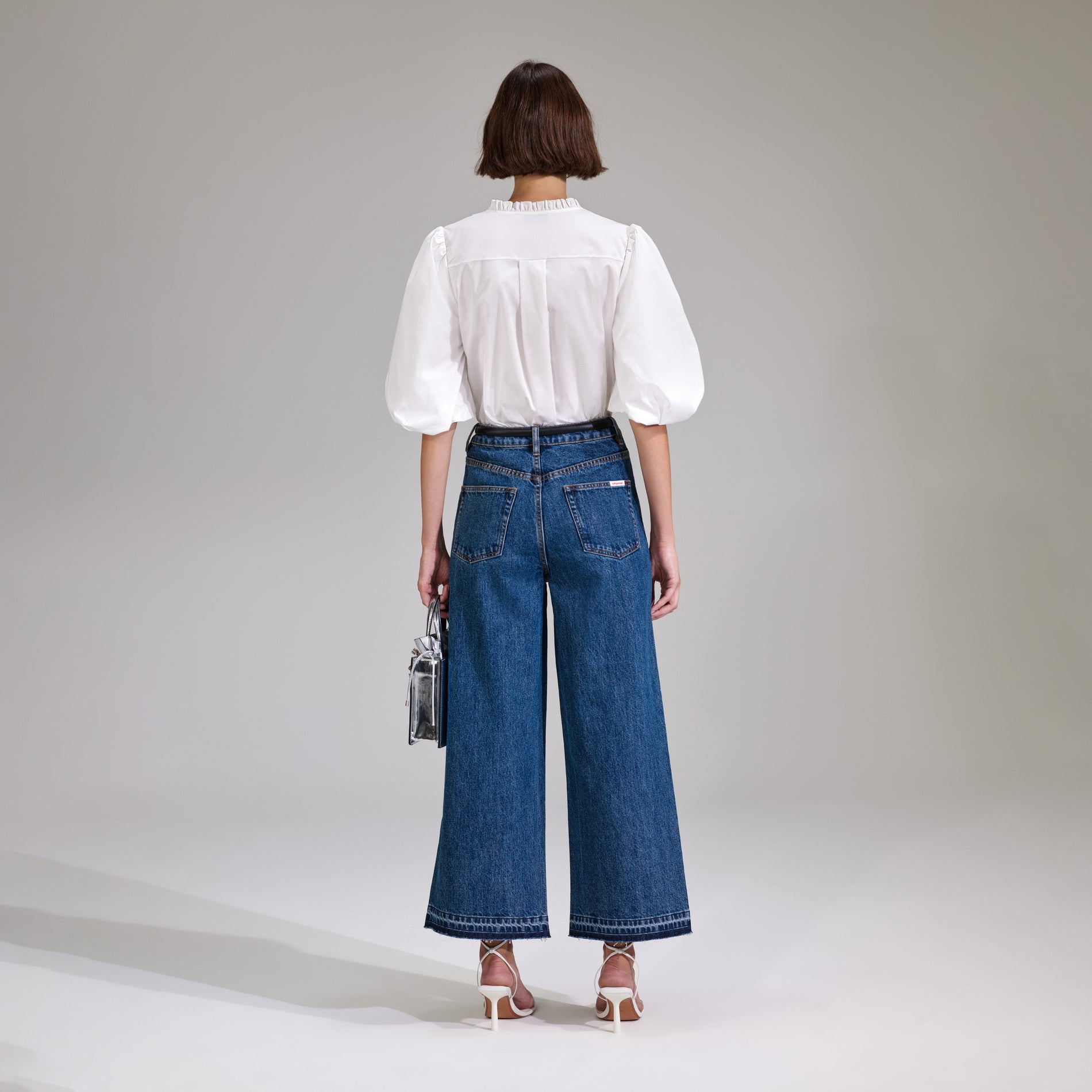 A woman wearing the White Cotton Poplin Top