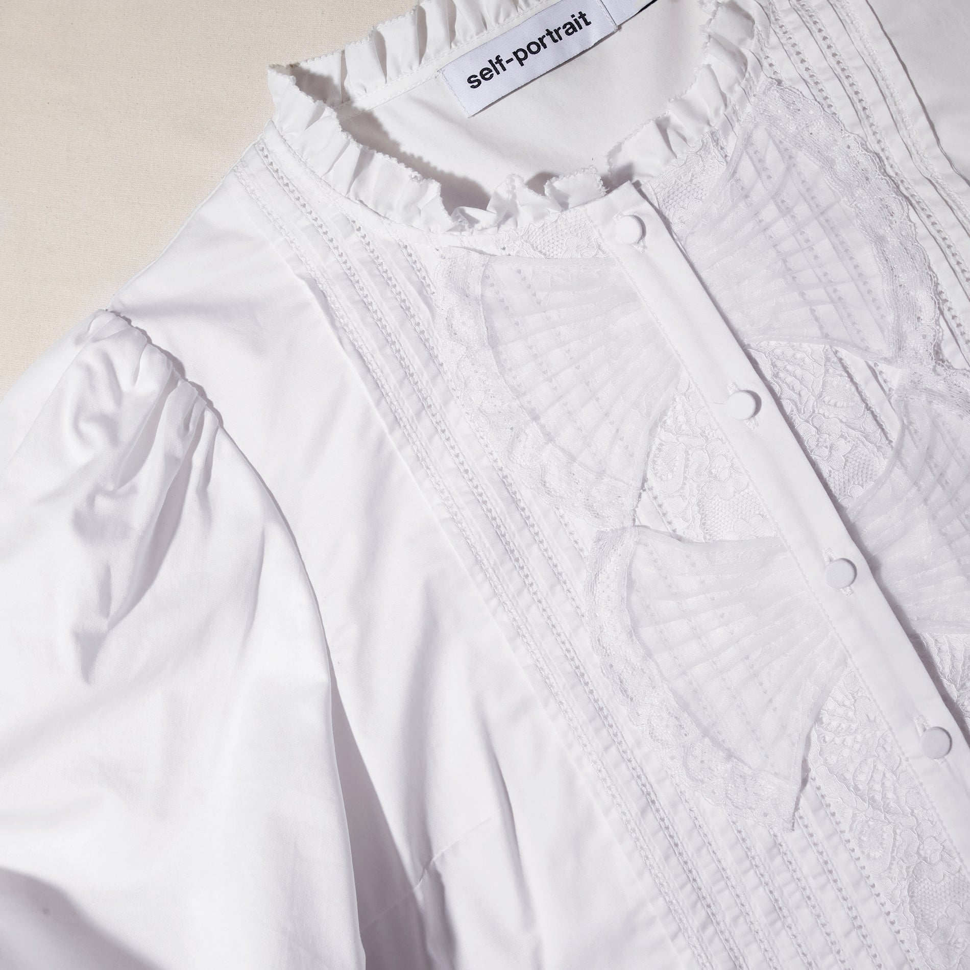 A close up of the fabric for the White Cotton Poplin Top