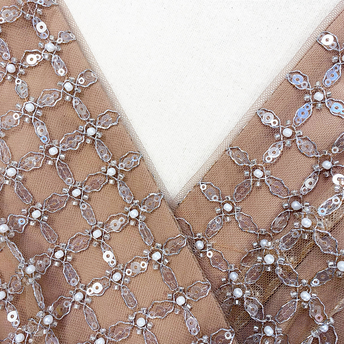 A close up of the fabric for the Tan Grid Sequin Tiered Midi Dress