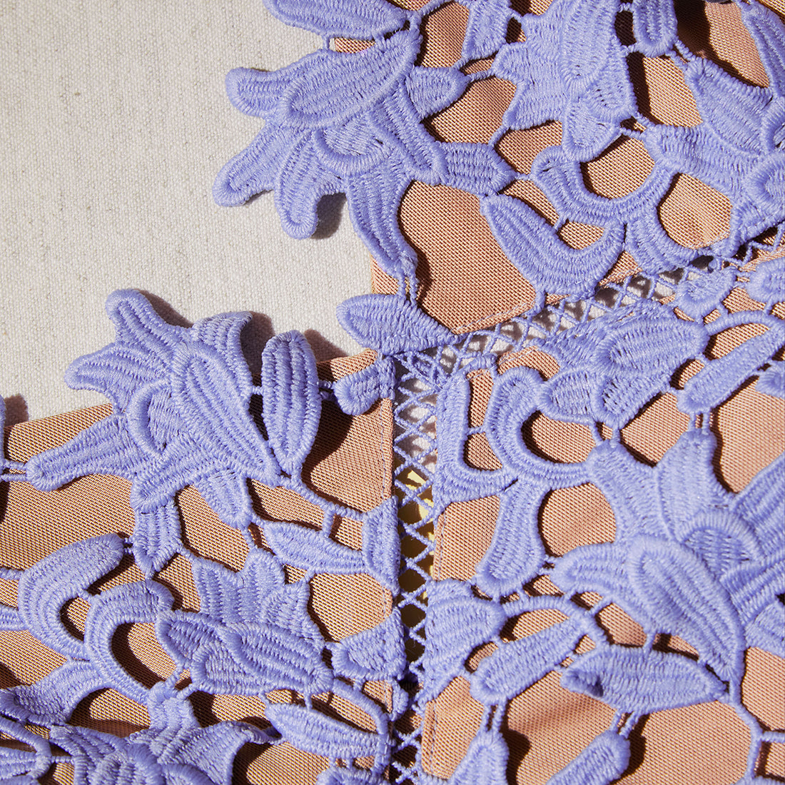 A close up of the fabric for the Lilac Azaelea Lace Mini Dress