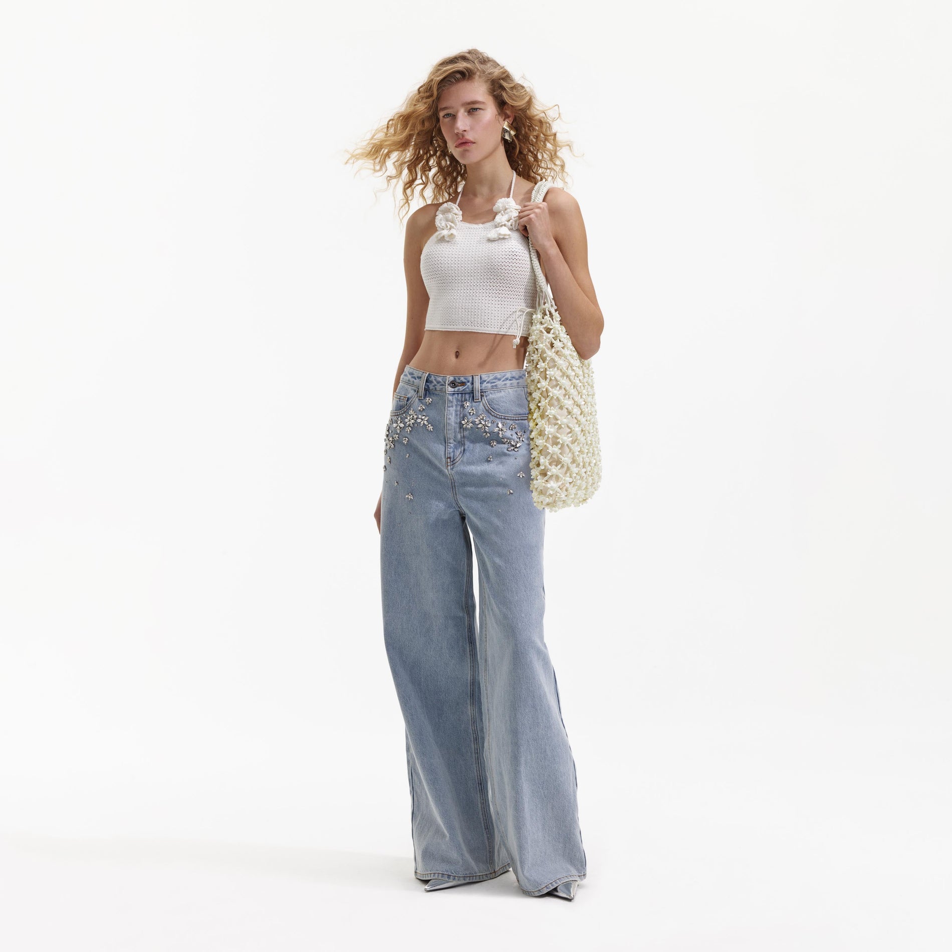 Side view of a woman wearing the White Crochet Crop Top