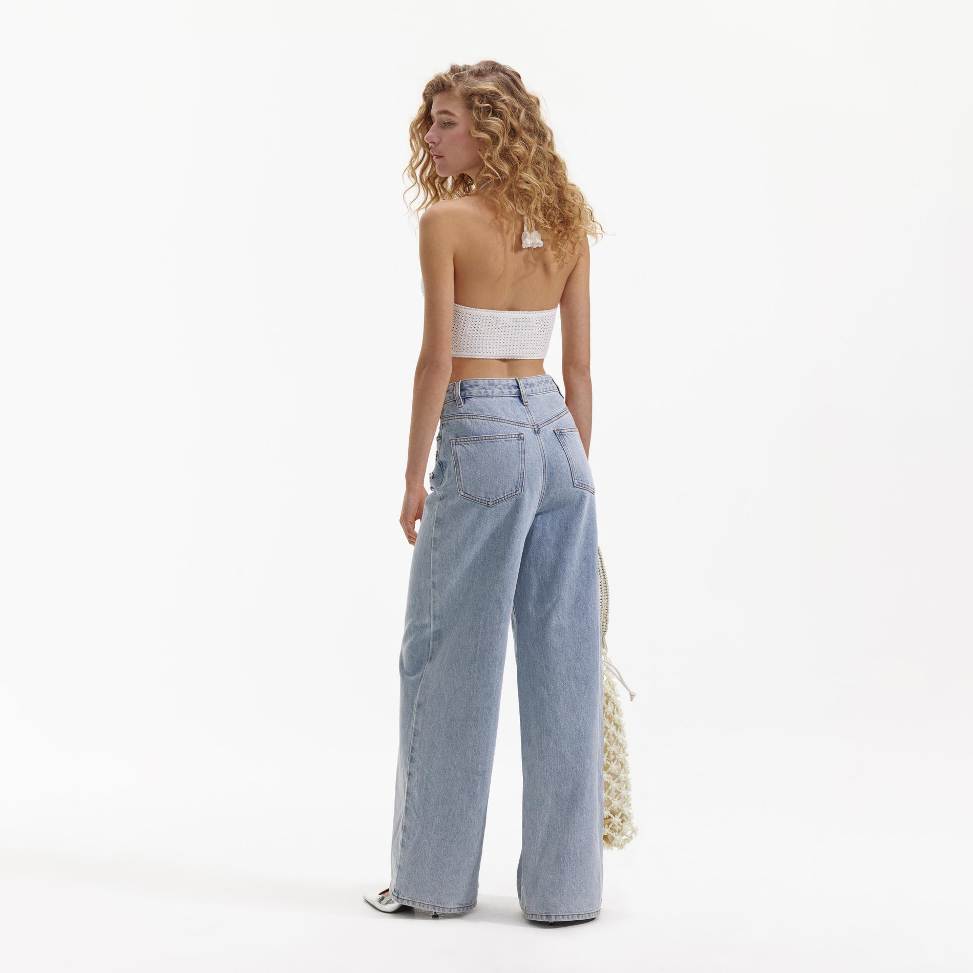 Back view of a woman wearing the White Crochet Crop Top