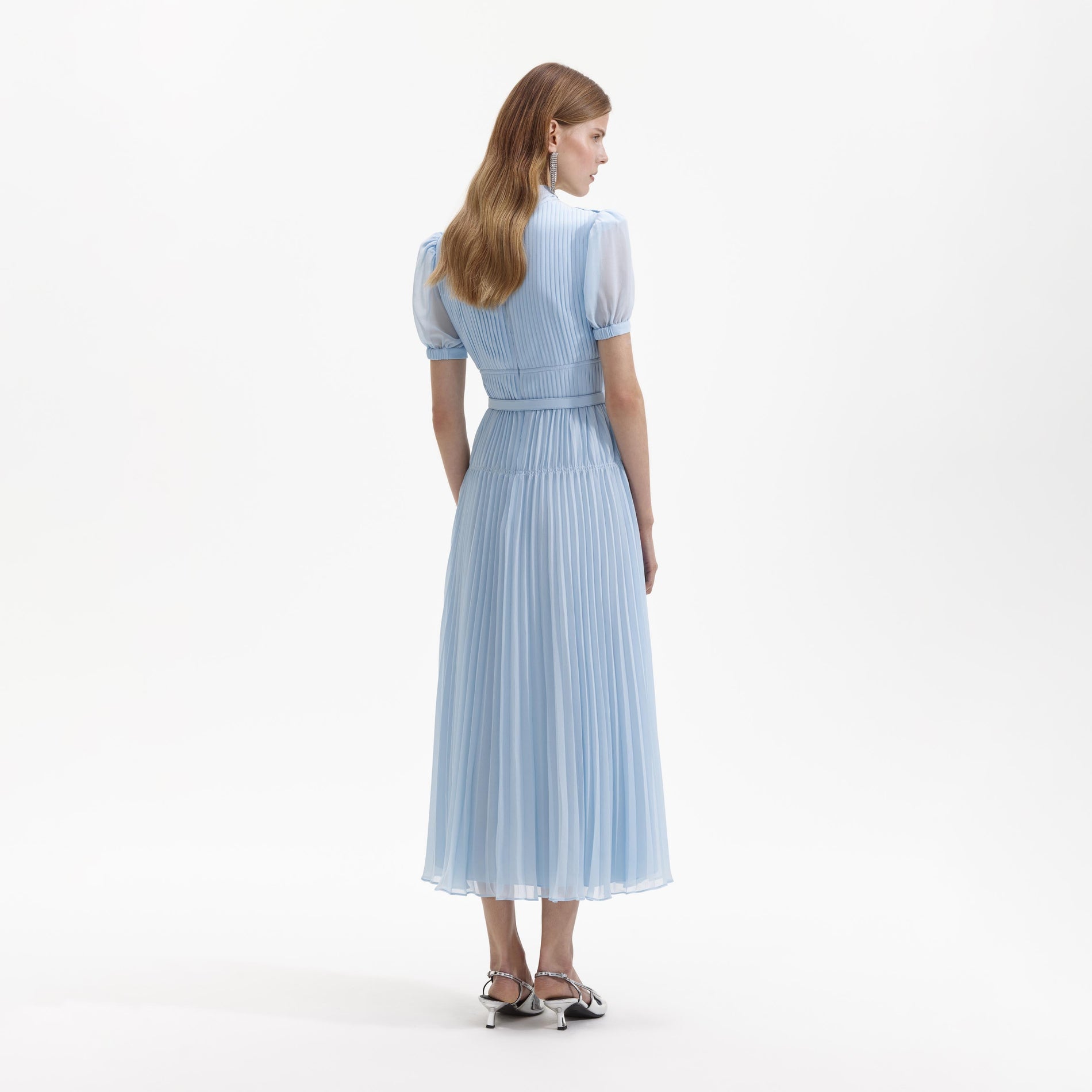 Back view of a woman wearing the Blue Chiffon Bow Midi Dress