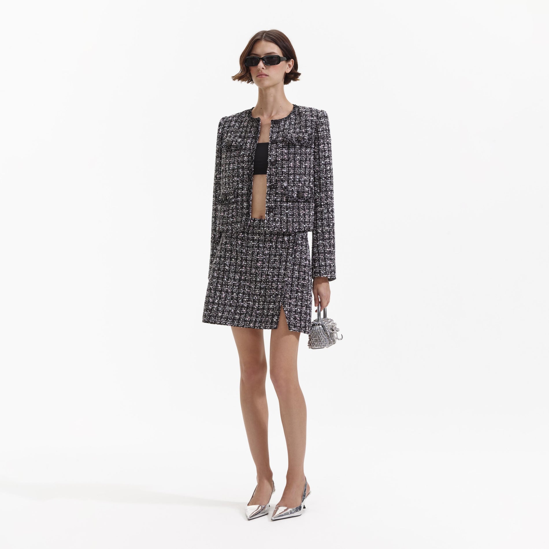 Side view of a woman wearing the Black Check Boucle Jacket