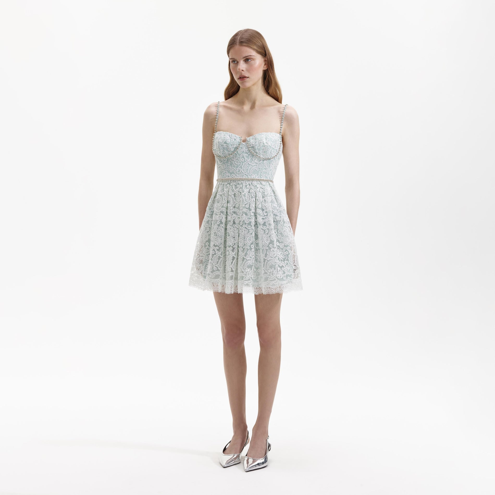 Side view of a woman wearing the Green Cord Lace Mini Dress