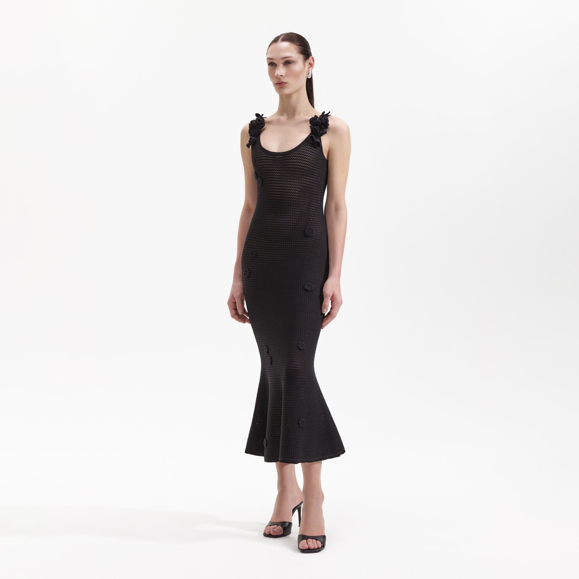 Side view of a woman wearing the Black Crochet Midi Dress