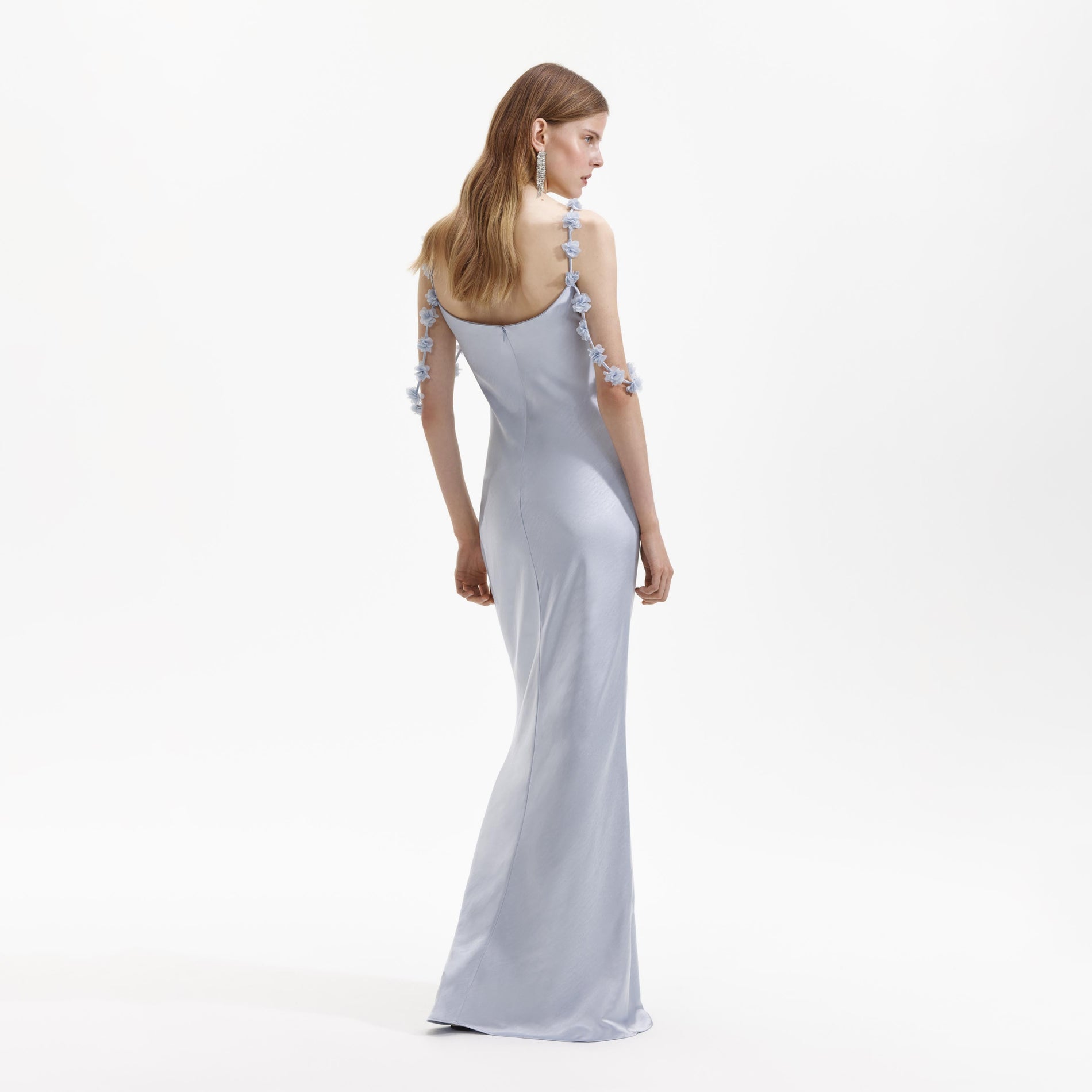 Back view of a woman wearing the Blue Satin Flower Maxi Dress